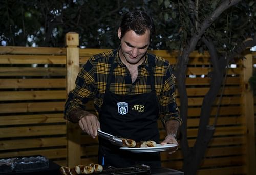 Roger Federer serving food- Source: Getty