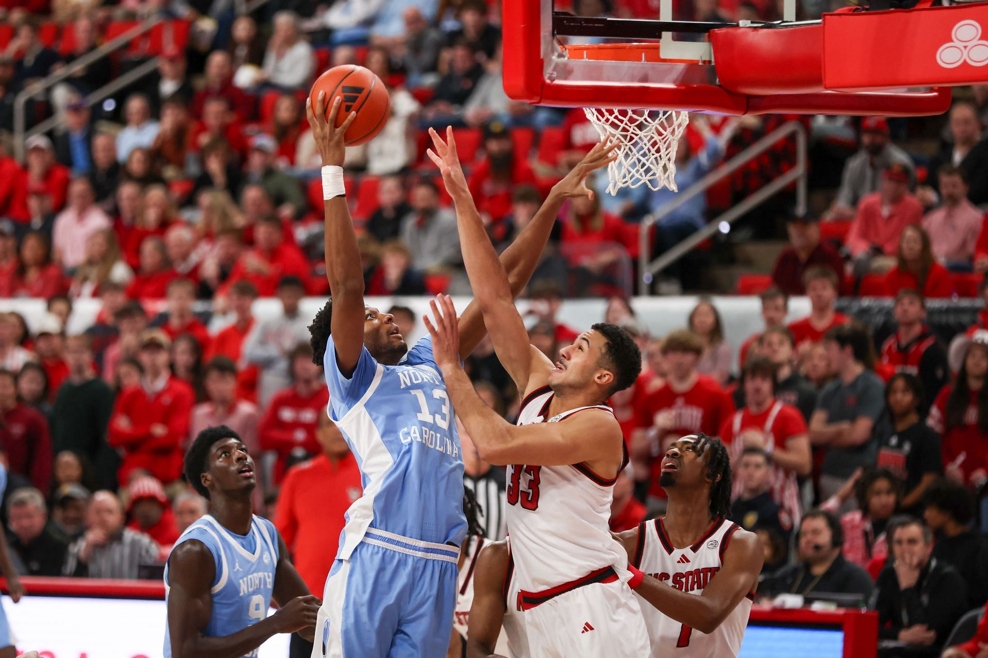 North Carolina Tar Heels forward Jalen Washington (#13) goes up over North Carolina State Wolfpack forward Ismael Diouf (#33) during their game on January 11, 2025 at the Lenovo Center in Raleigh, NC. Photo: Getty