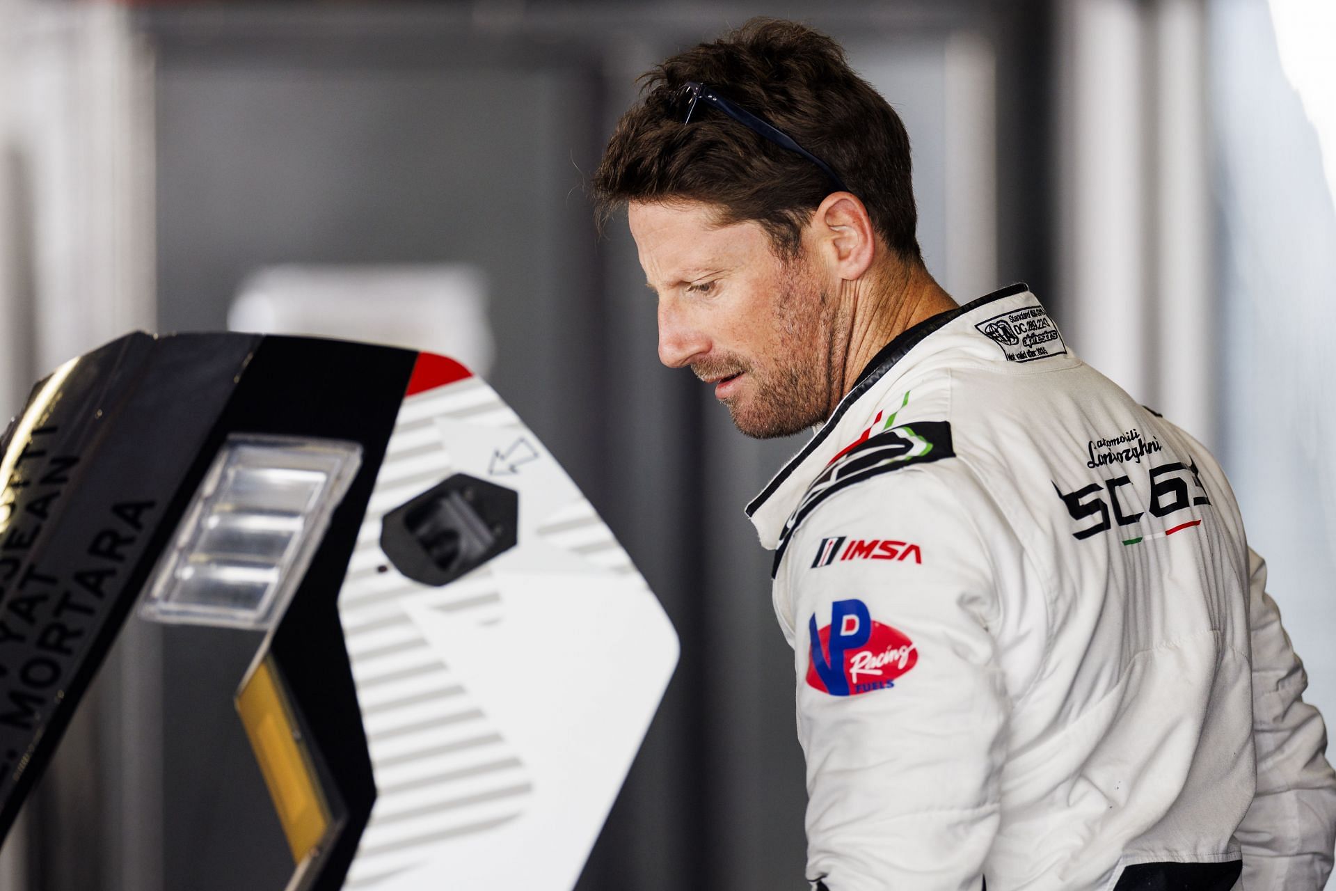 Romain Grosjean looks on in the garage during the Roar Before The 24h at Daytona International Speedway on January 17, 2025- Source: Getty