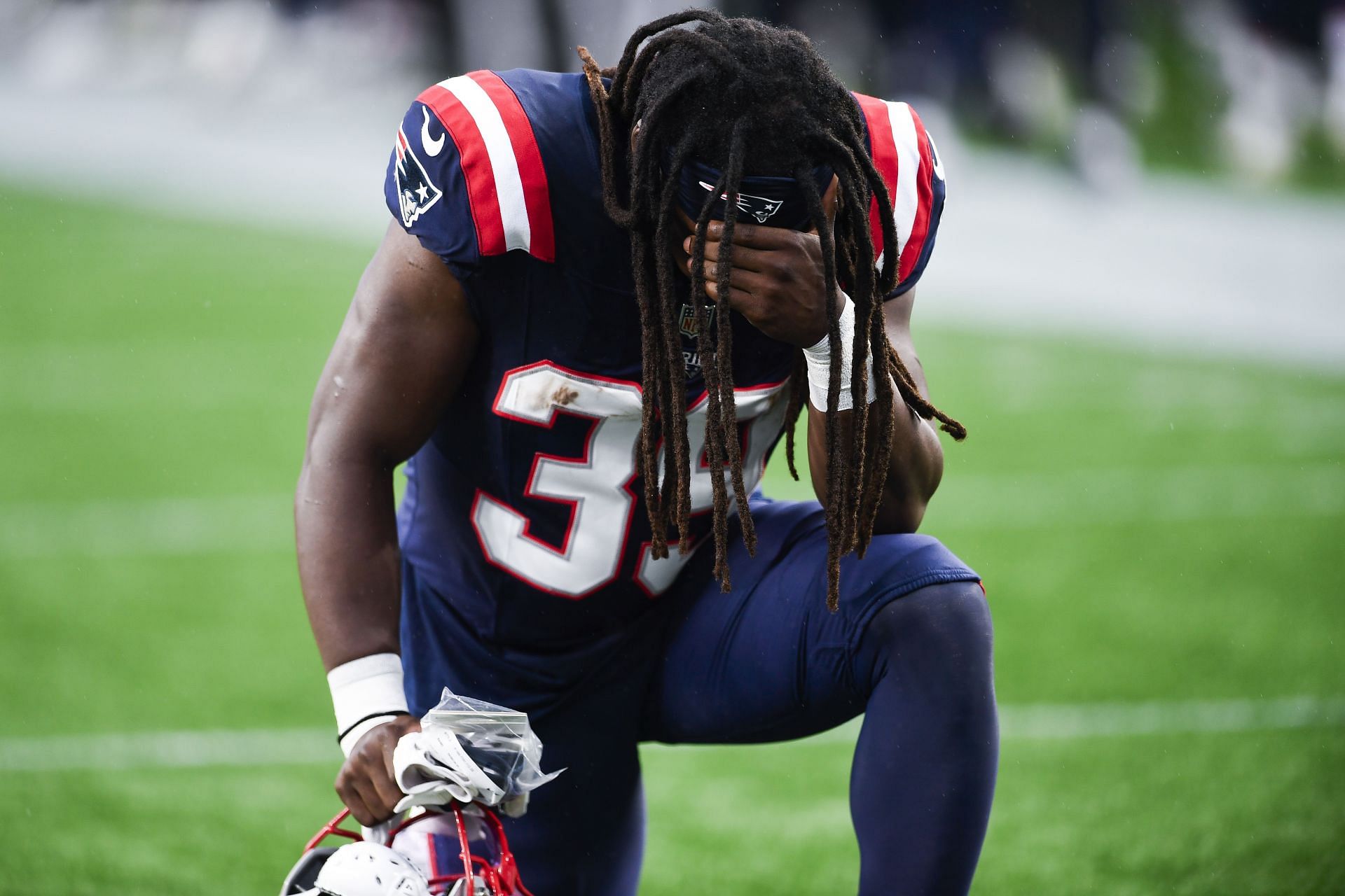 JaMycal Hasty of the New England Patriots kneels before a game - Source: Getty