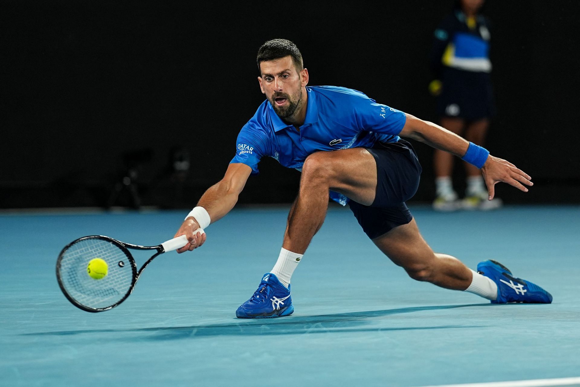 Novak Djokovic picks up a ball in Melbourne (Source: Getty)