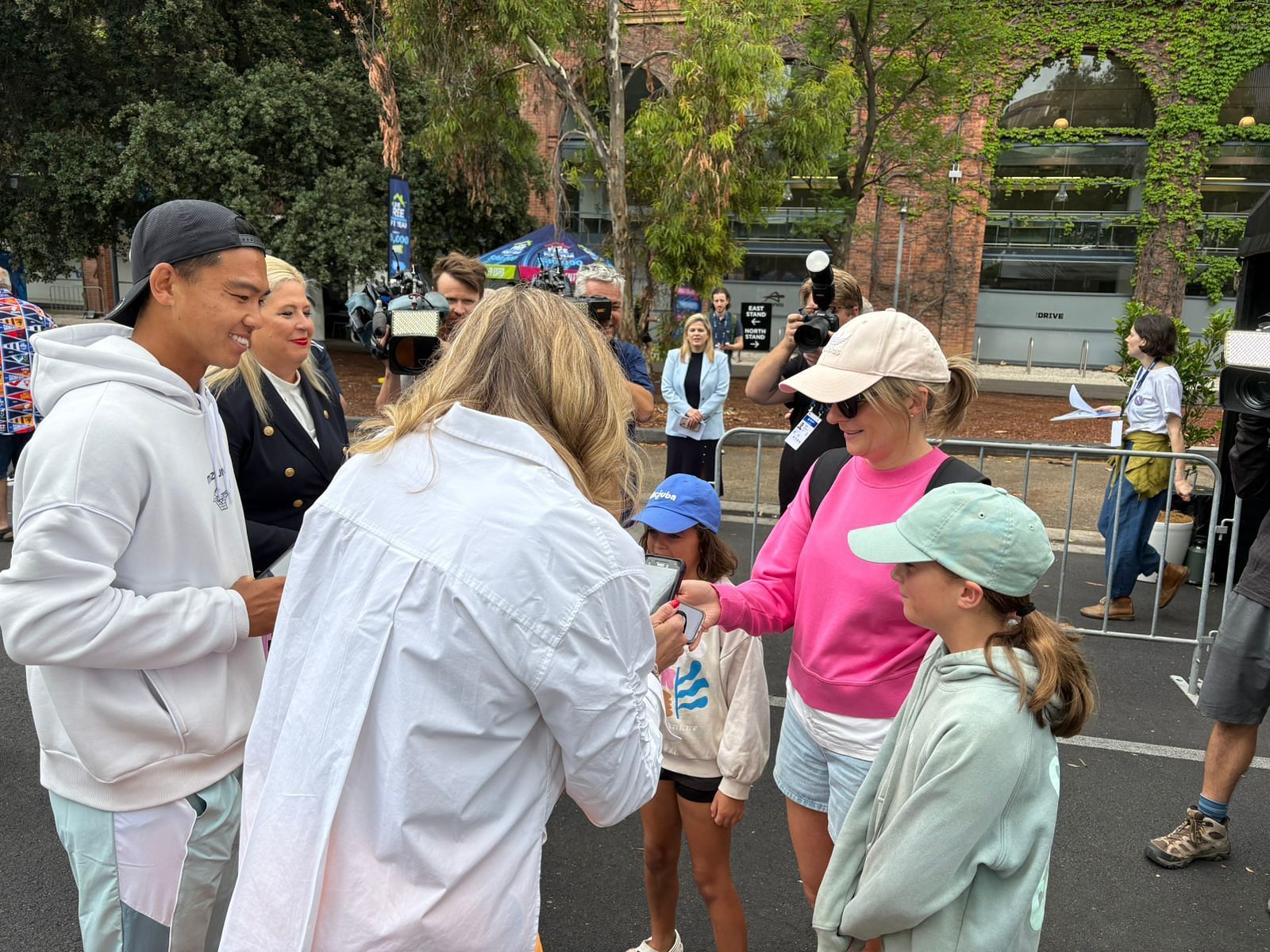 Li Tu (L), Alicia Molik (turned back), and Hone Katerine Hildyard scanned tickets.