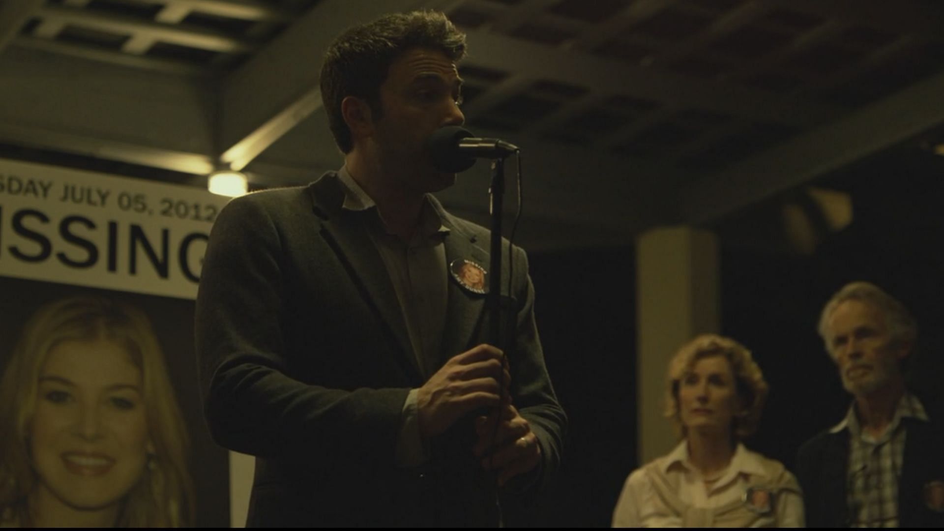 Ben Affleck in Gone Girl making an announcement. (Image via Apple TV)