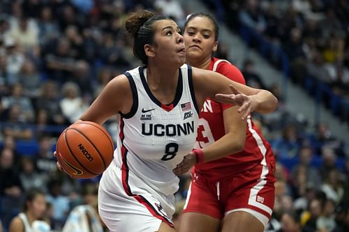 Jana El-Alfy (#8) of the UConn Huskies drives to the basket against Channing Warren (#23) of the Boston University Terriers during the second half of their NCAA game at the XL Center on November 7, 2024 in Hartford, Connecticut. Photo: Getty