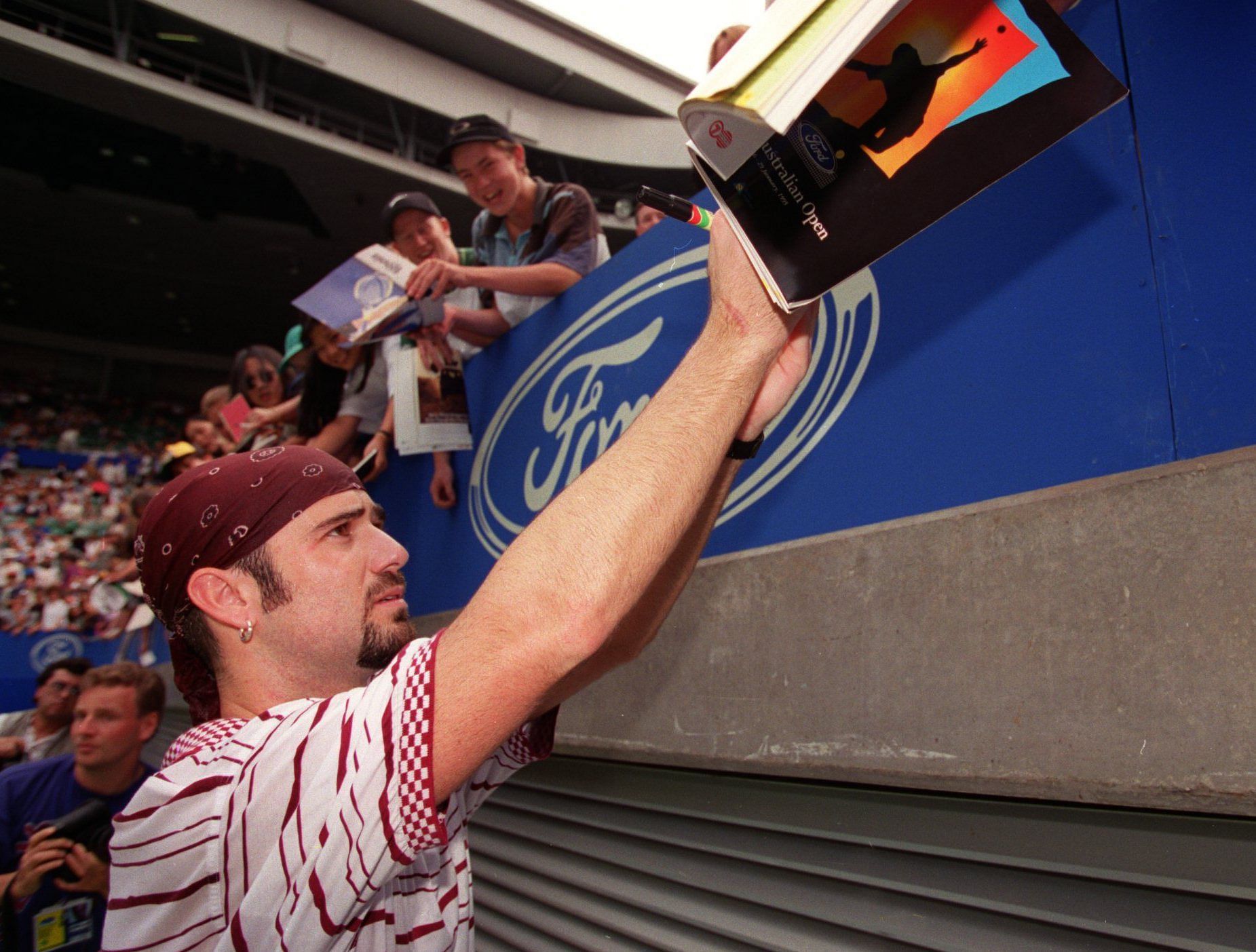 Andre Agassi signs autographs at the 1995 Australian Open - Source: Getty