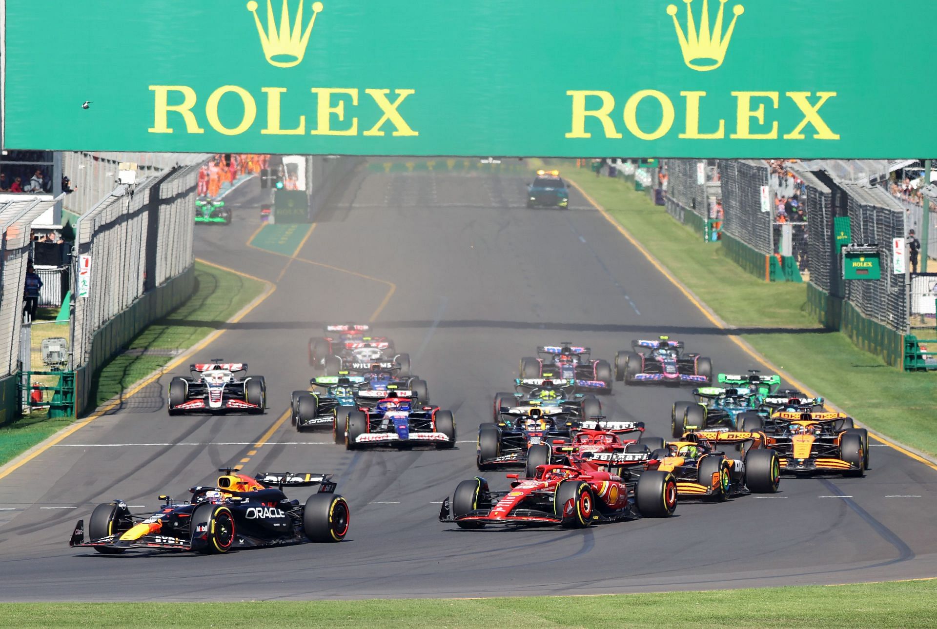 MELBOURNE, AUSTRALIA - MARCH 24: Carlos Sainz of Spain driving the Ferrari SF-24 and Max Verstappen of the Netherlands driving the Oracle Red Bull Racing RB19 and Lando Norris of Great Britain driving the McLaren F1 Team MCL60 on track during the F1 Grand Prix of Australia at Albert Park Circuit on March 24, 2024 in Melbourne, Australia. (Photo by Clay Cross ATPImages/Getty Images) - Source: Getty