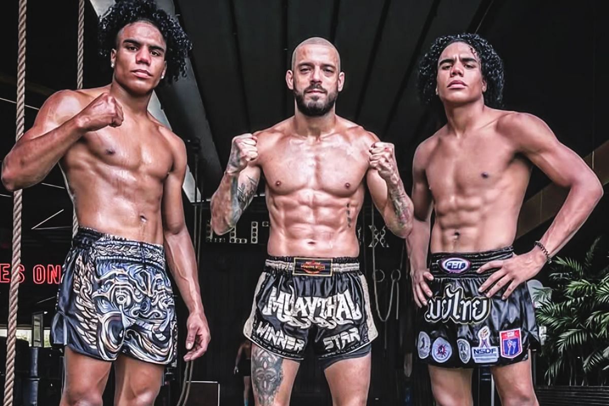 Jordan Estupinan (left) and Johan Estupinan (right) with their coach JC Fernandez (center). [Photo via: ONE Championship]