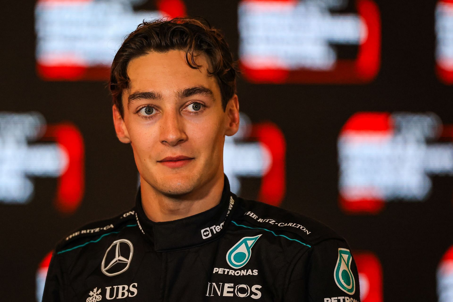 George Russell of Great Britain and Mercedes answers questions in the TV media pen- Source: Getty