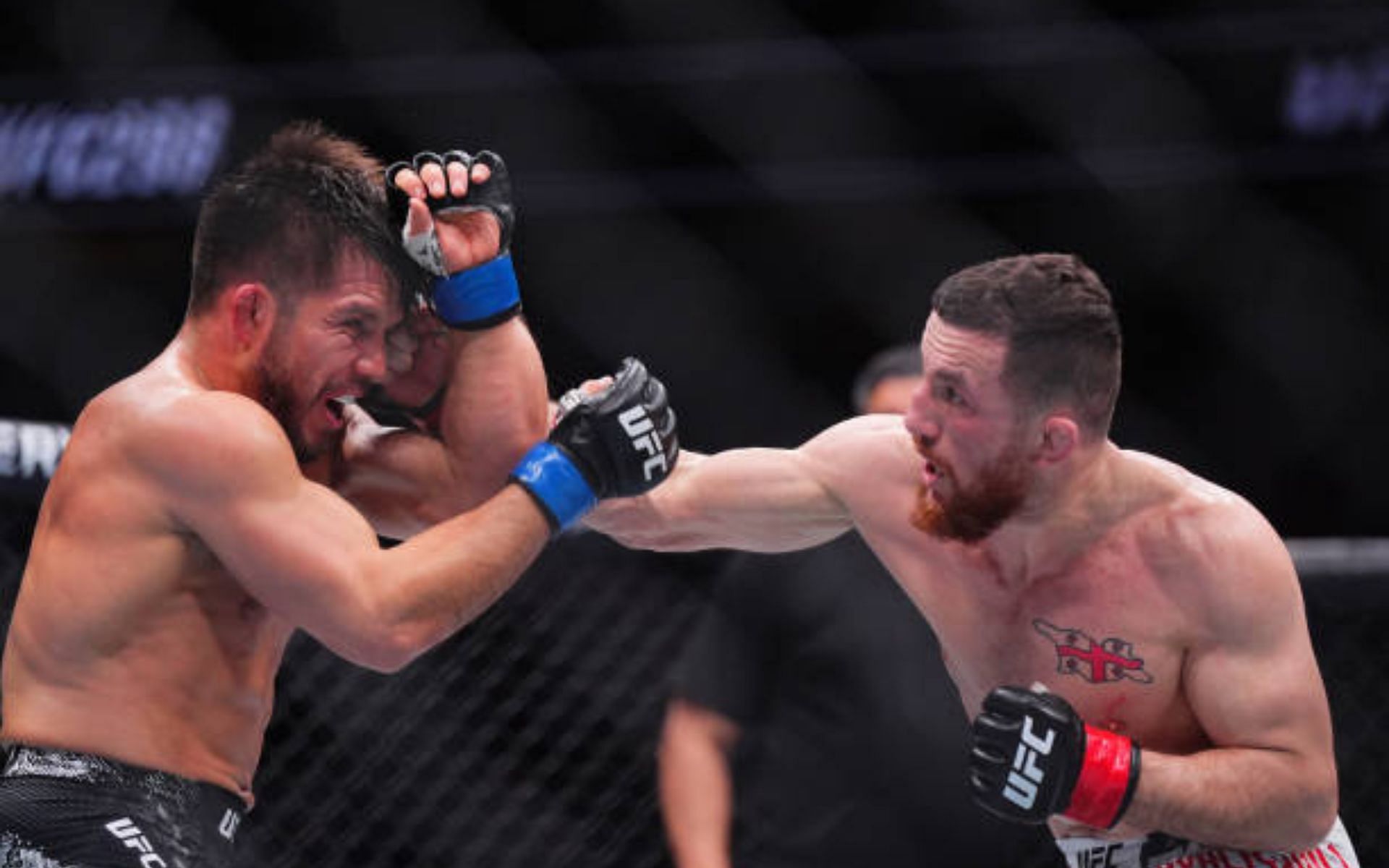 Henry Cejudo (left) discusses Merab Dvalishvili