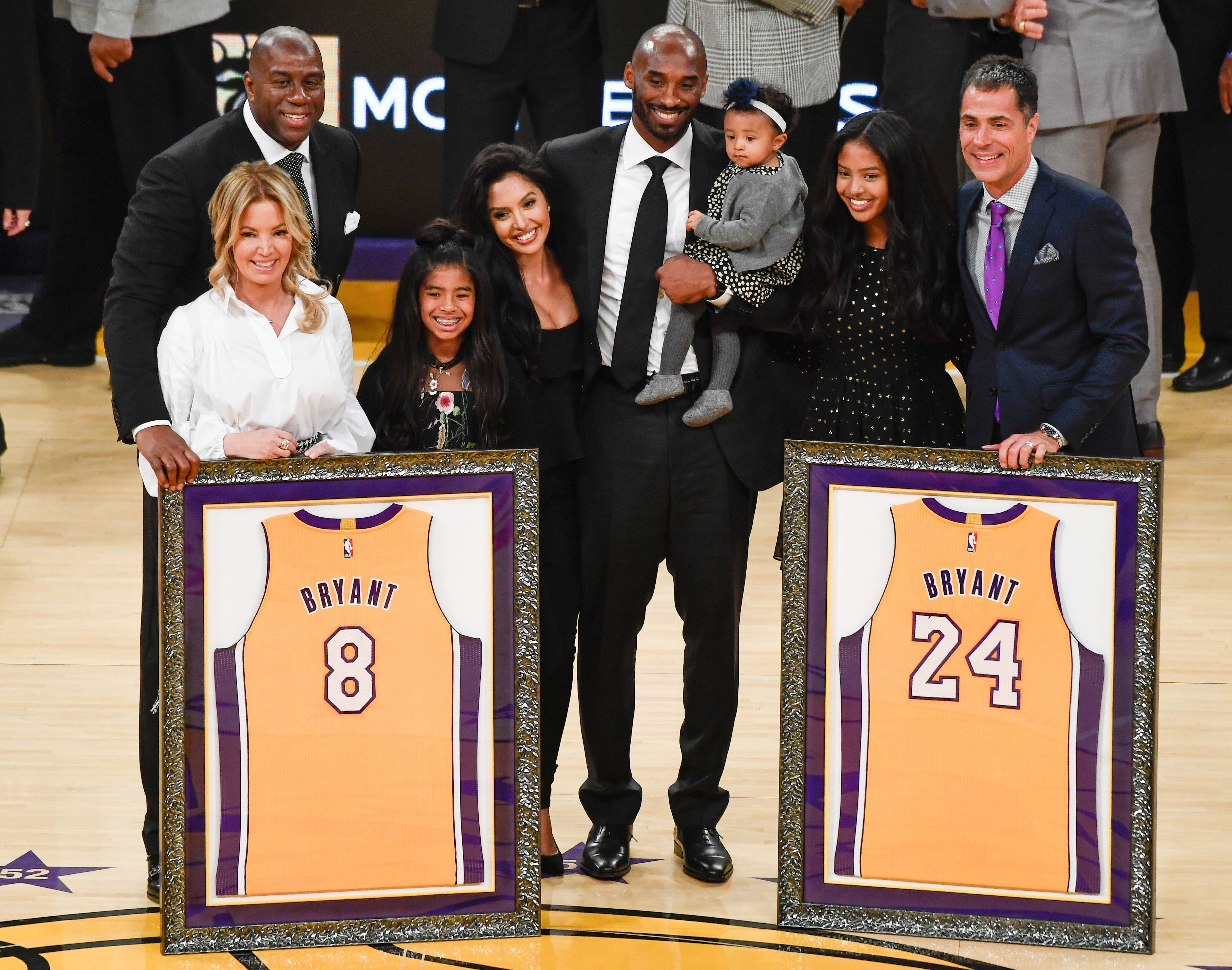 Dec 18, 2017; Los Angeles, CA, USA; Earvin \&quot;Magic\&quot; Johnson, Jeannie Buss, Gianna Bryant, Vanessa Bryant, Kobe Bryant holding Bianka Bryant, Natalia Bryant and Rob Pelinka pose for photos during a halftime ceremony retiring Kobe Bryant