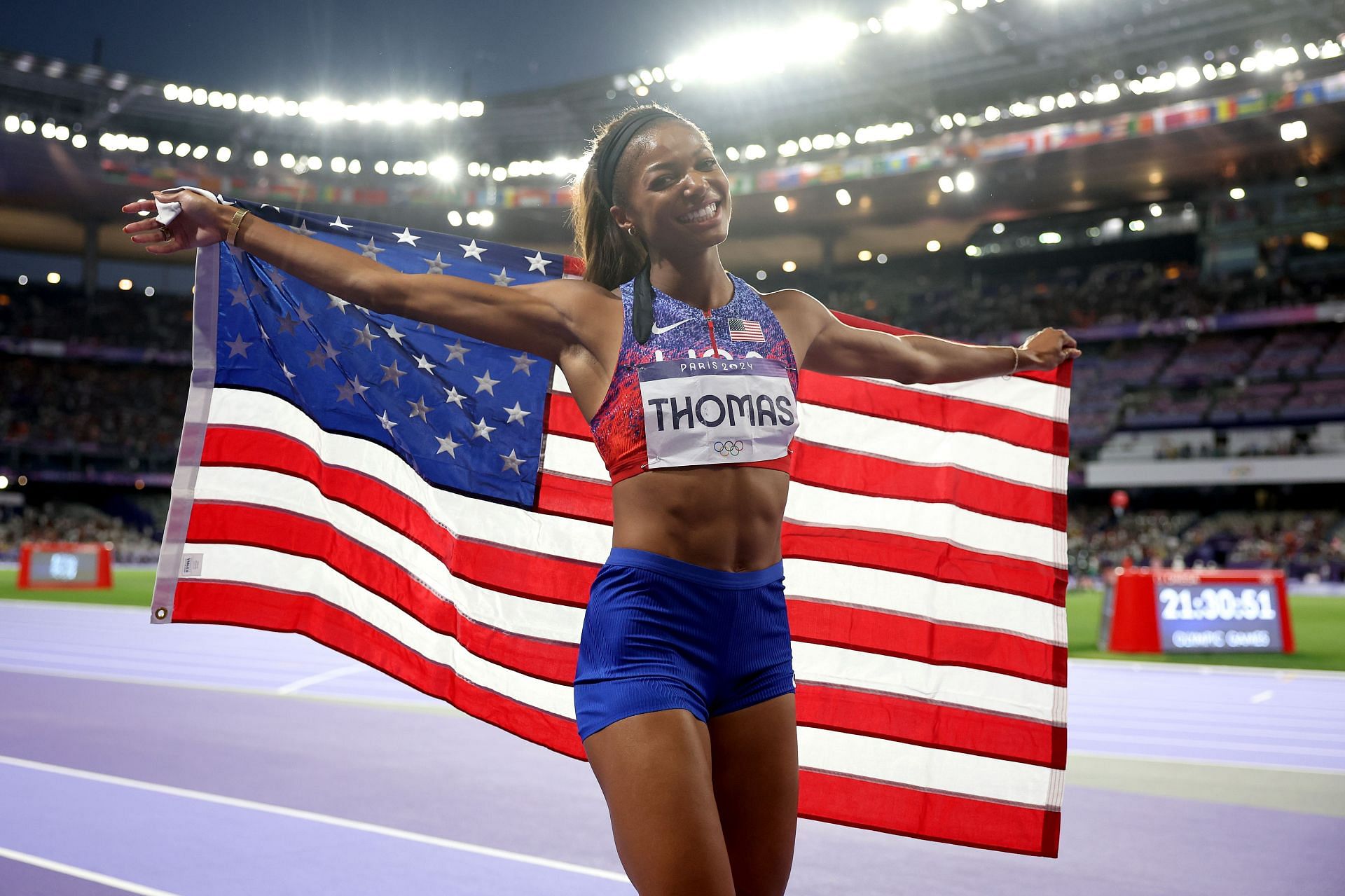 Gabby Thomas with the US flag at the Olympic Games Paris 2024: Day 15 - (Source: Getty)