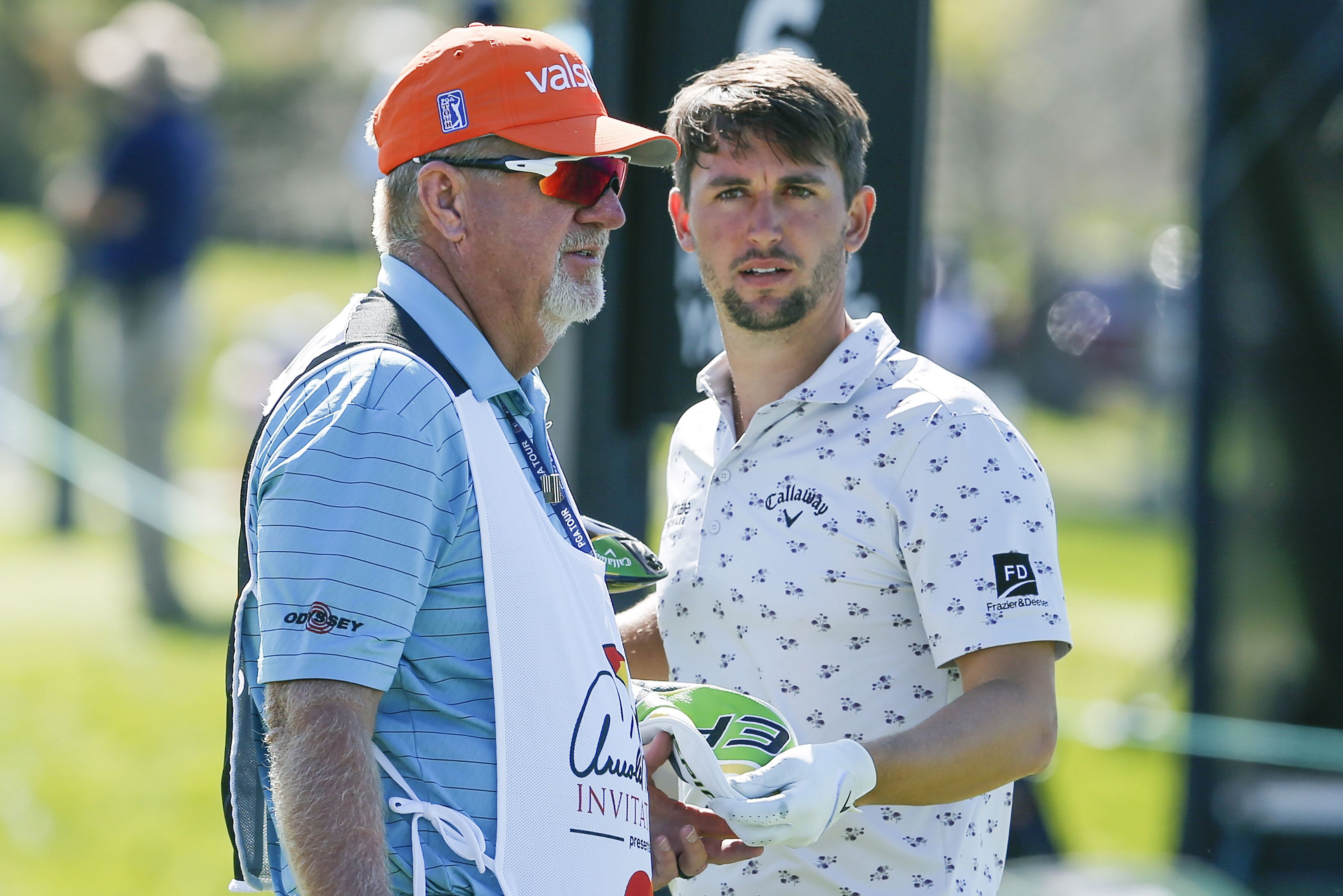 Ollie Schneiderjans (right) and his caddie Damon Green (left) talk on the sixth tee box during the second round of the Arnold Palmer Invitational golf tournament - Source: Imagn