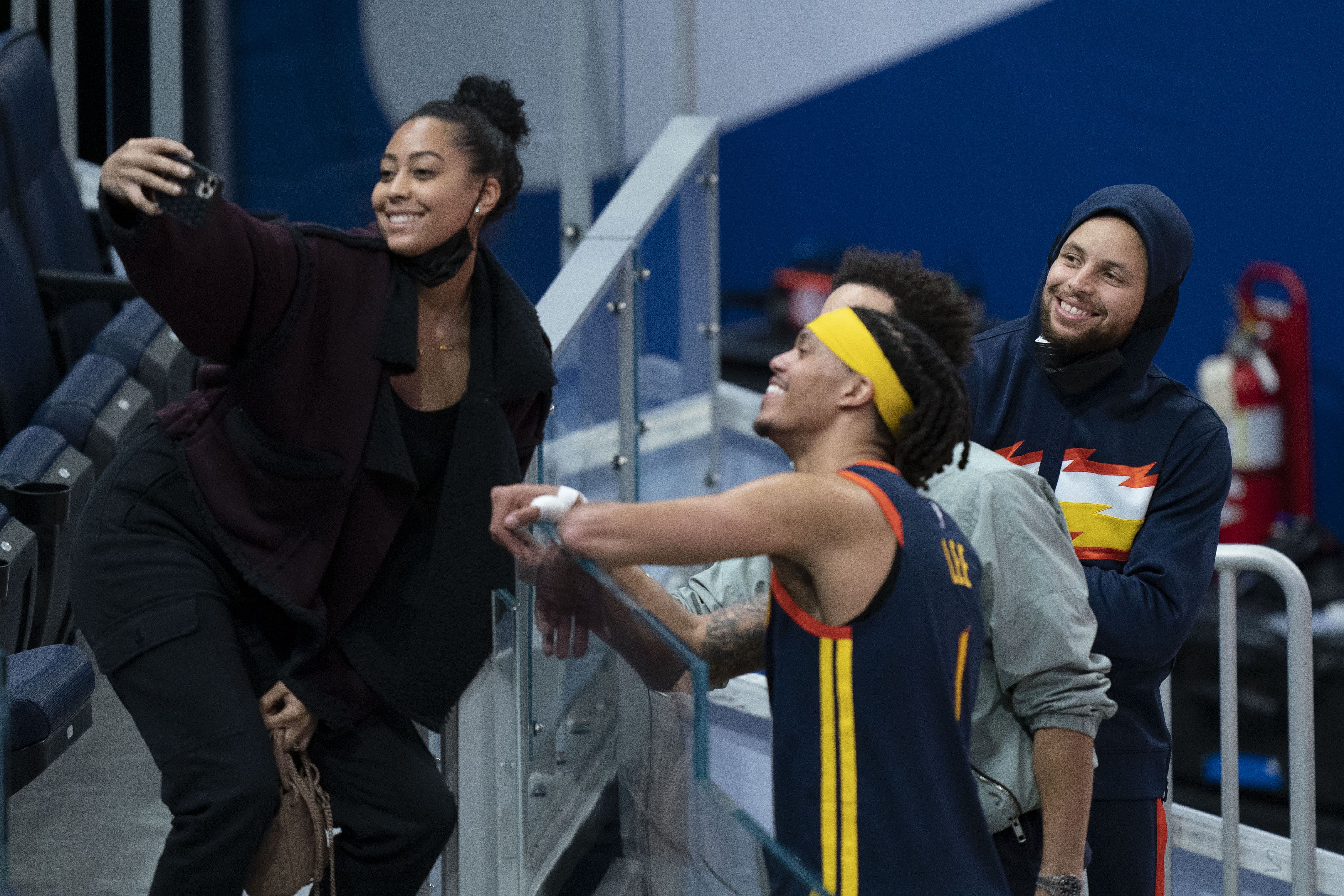 March 23, 2021; San Francisco, California, USA; Sydel Curry (far left) takes a selfie with Golden State Warriors guard Damion Lee (second from left), Philadelphia 76ers guard Seth Curry (second from right), and Warriors guard Stephen Curry (far right) after the game at Chase Center. Mandatory Credit: Kyle Terada-Imagn Images - Source: Imagn