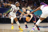 UConn Huskies guard Paige Bueckers (5) controls the ball between South Carolina Gamecocks guard Bree Hall (23) and forward Aliyah Boston (4) in the championship game of the NCAA Tournament at Target Center. Photo: Imagn