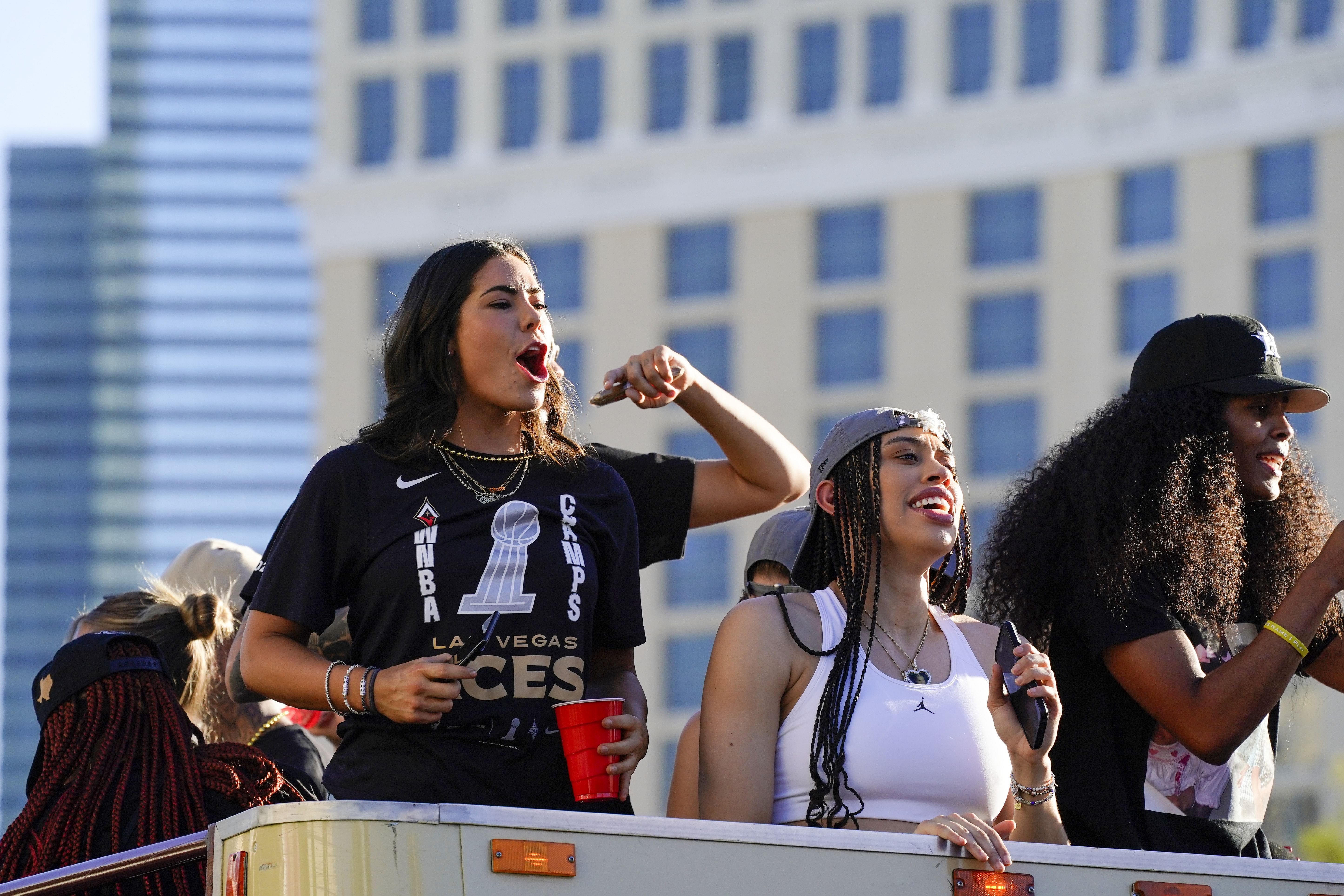 Las Vegas Aces guard Kelsey Plum celebrates with Dearica Hamby and Sydney Colson during the Las Vegas Aces championship parade in Las Vegas. Photo Credit: Imagn