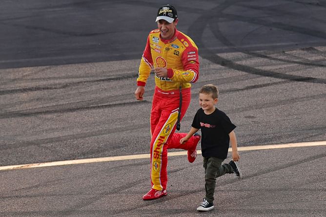 NASCAR’s Joey Logano spotted with son Hudson backing six-time NCAA champion university