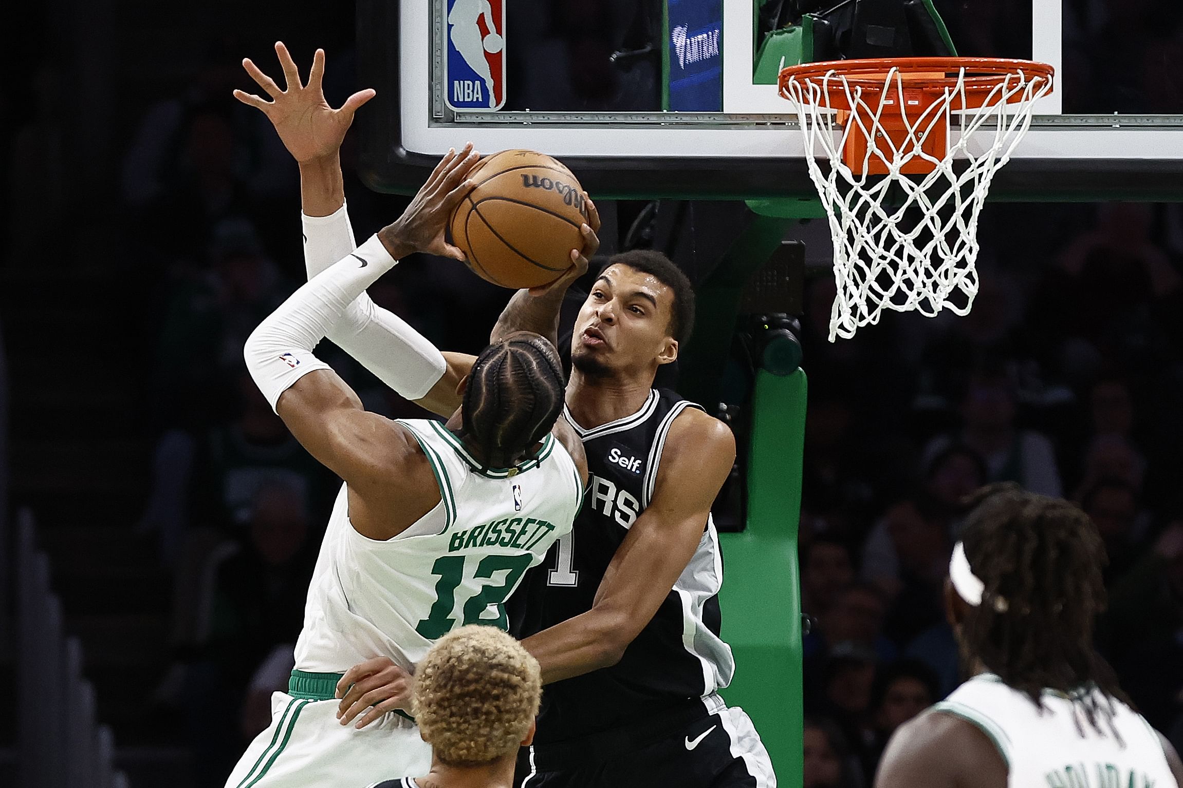 Jan 17, 2024; Boston, Massachusetts, USA; San Antonio Spurs center Victor Wembanyama (1) tries to stop Boston Celtics forward Oshae Brissett (12) during the second half at TD Garden. Mandatory Credit: Winslow Townson-Imagn Images - Source: Imagn