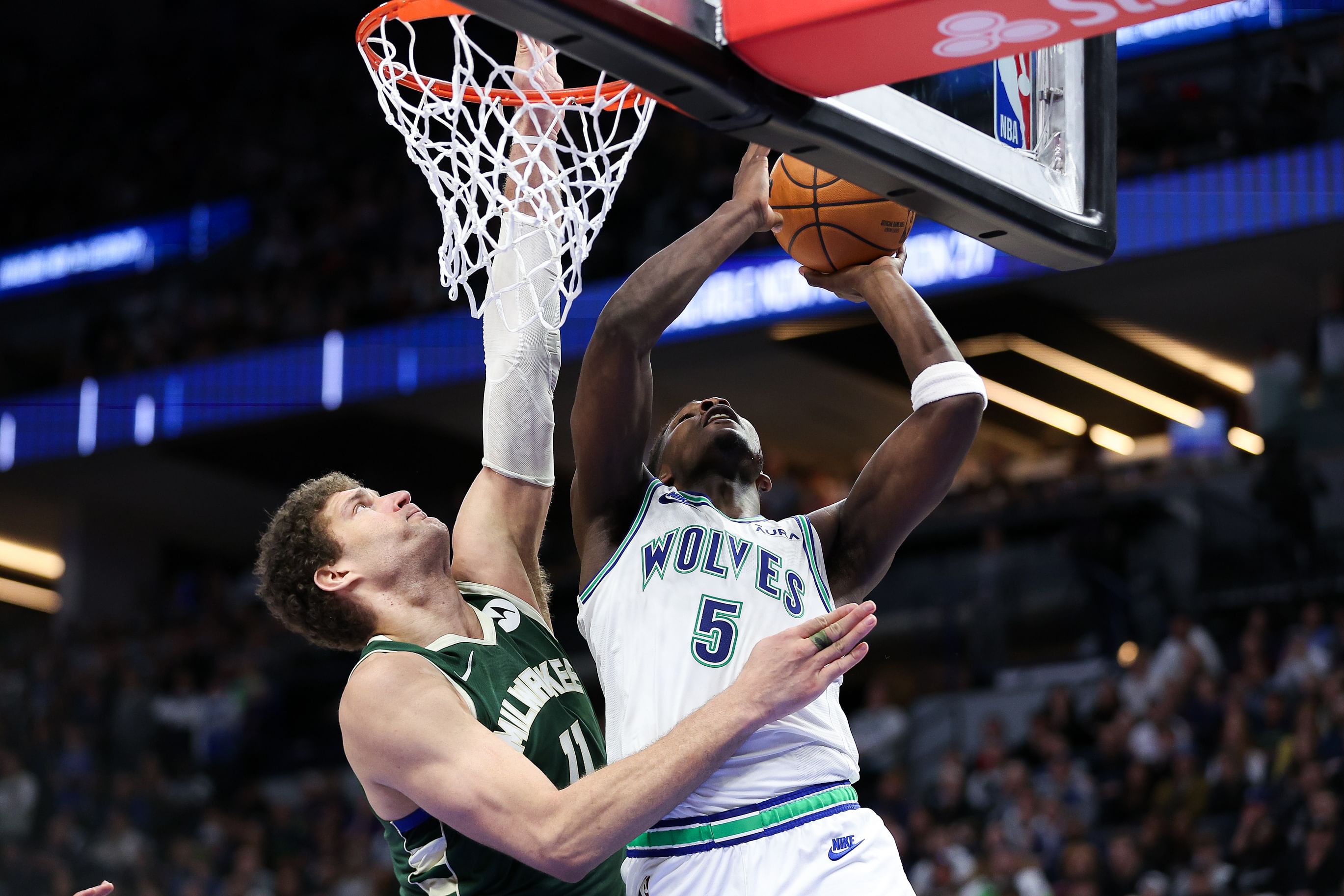 Feb 23, 2024; Minneapolis, Minnesota, USA; Minnesota Timberwolves guard Anthony Edwards (5) shoots as Milwaukee Bucks center Brook Lopez (11) defends during the second half at Target Center. Mandatory Credit: Matt Krohn-Imagn Images - Source: Imagn