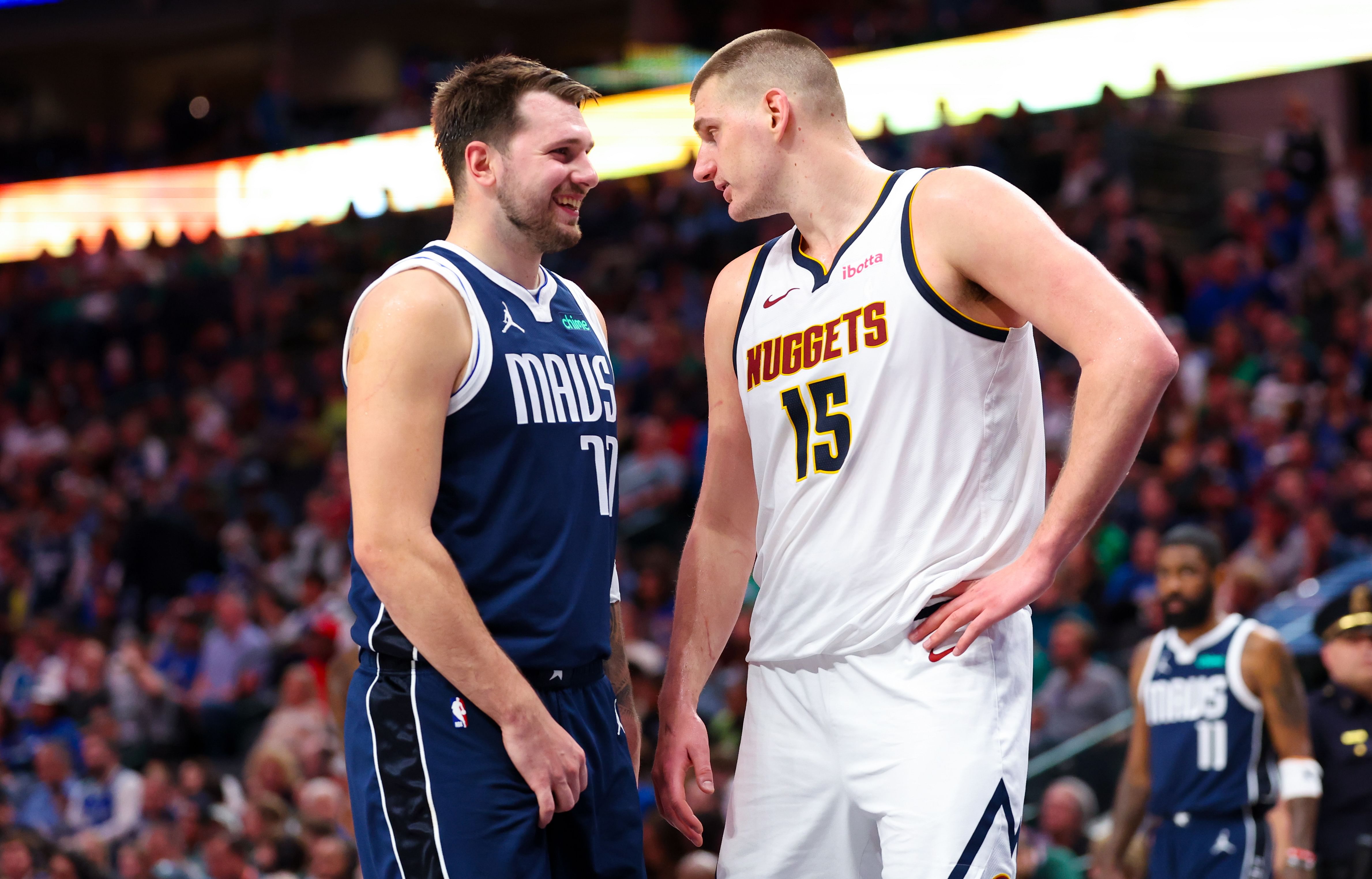 Dallas Mavericks guard Luka Doncic speaks with Denver Nuggets center Nikola Jokic at American Airlines Center. Photo Credit: Imagn