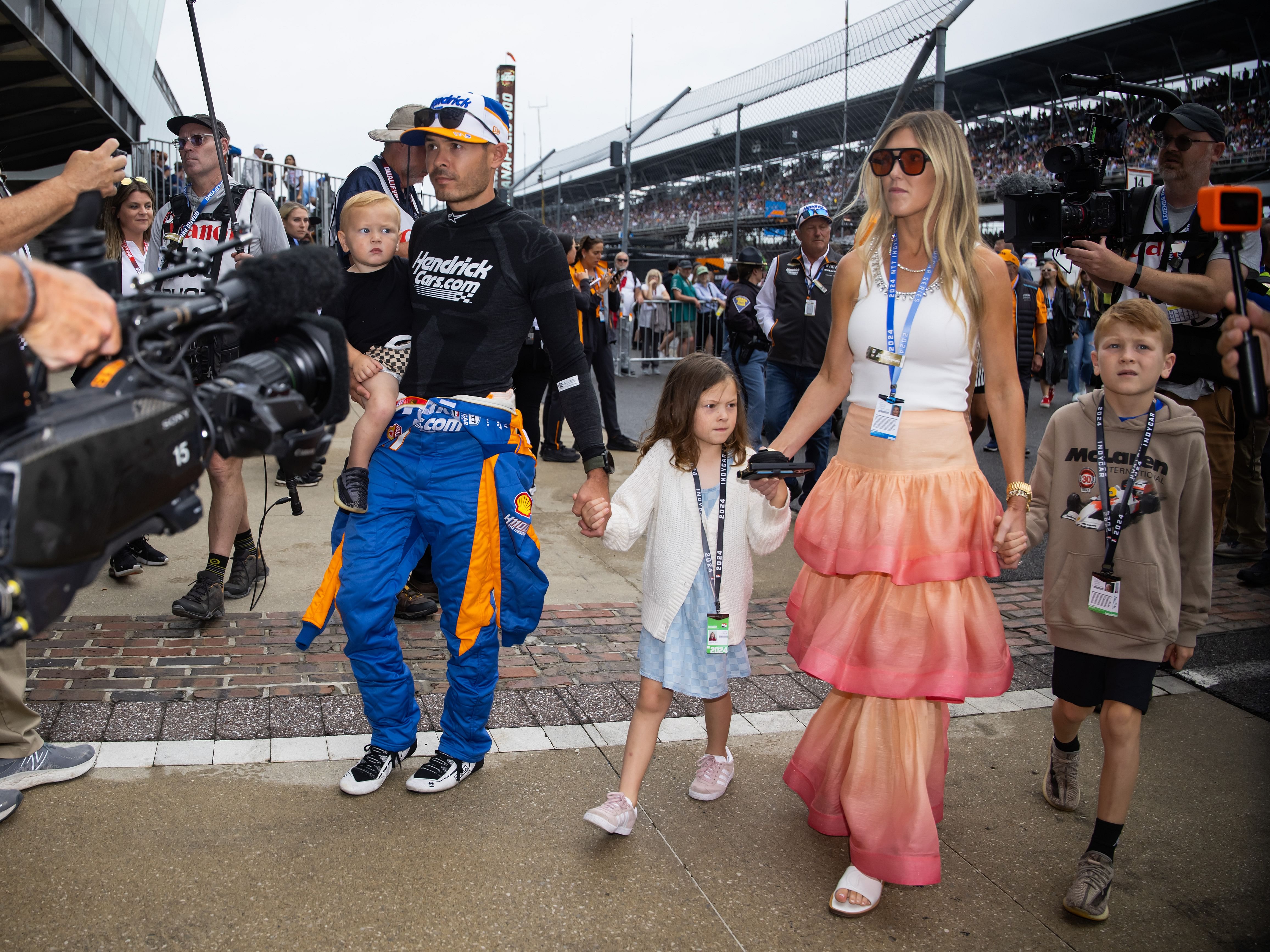 Kyle Larson holds son Cooper Larson as he walks with daughter Audrey Larson, wife Katelyn Larson, and son Owen Larson - Source: Imagn