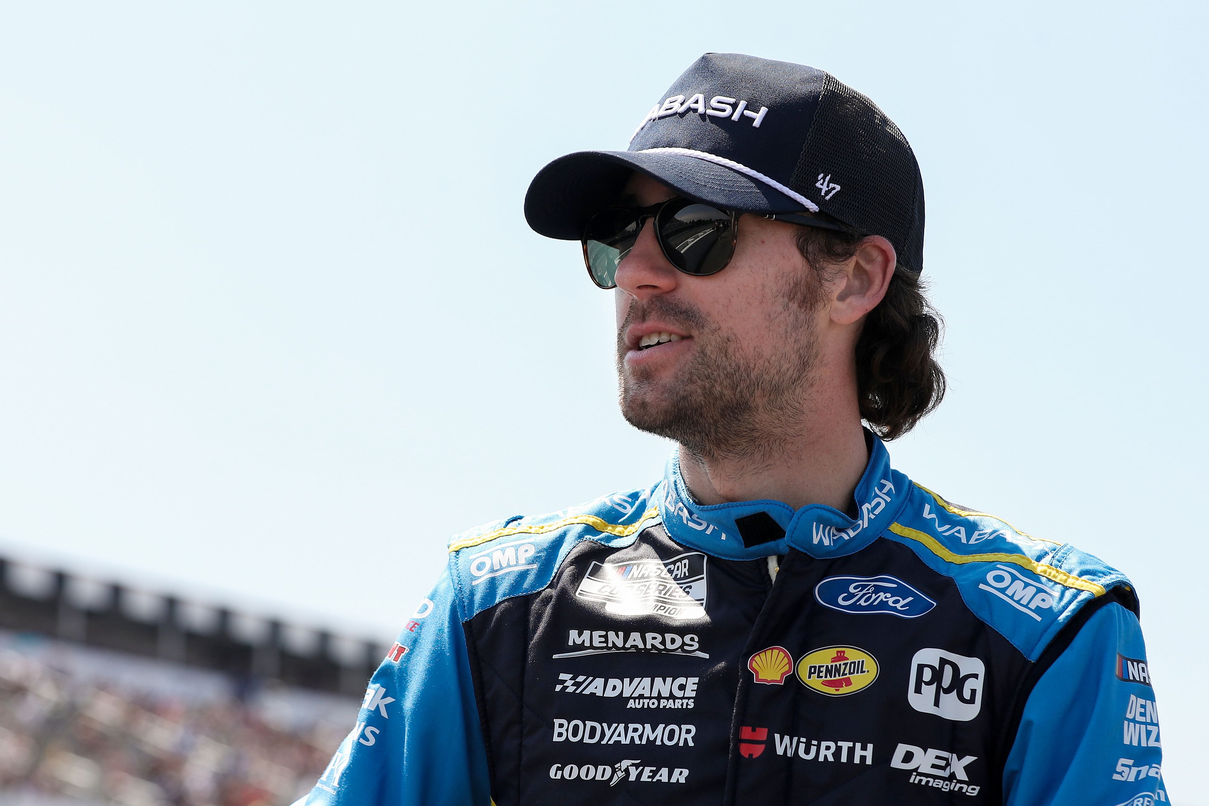 Jul 14, 2024; Long Pond, Pennsylvania, USA; NASCAR Cup Series driver Ryan Blaney stands on pit road prior to The Great American Getaway 400 at Pocono Raceway. Mandatory Credit: Matthew O