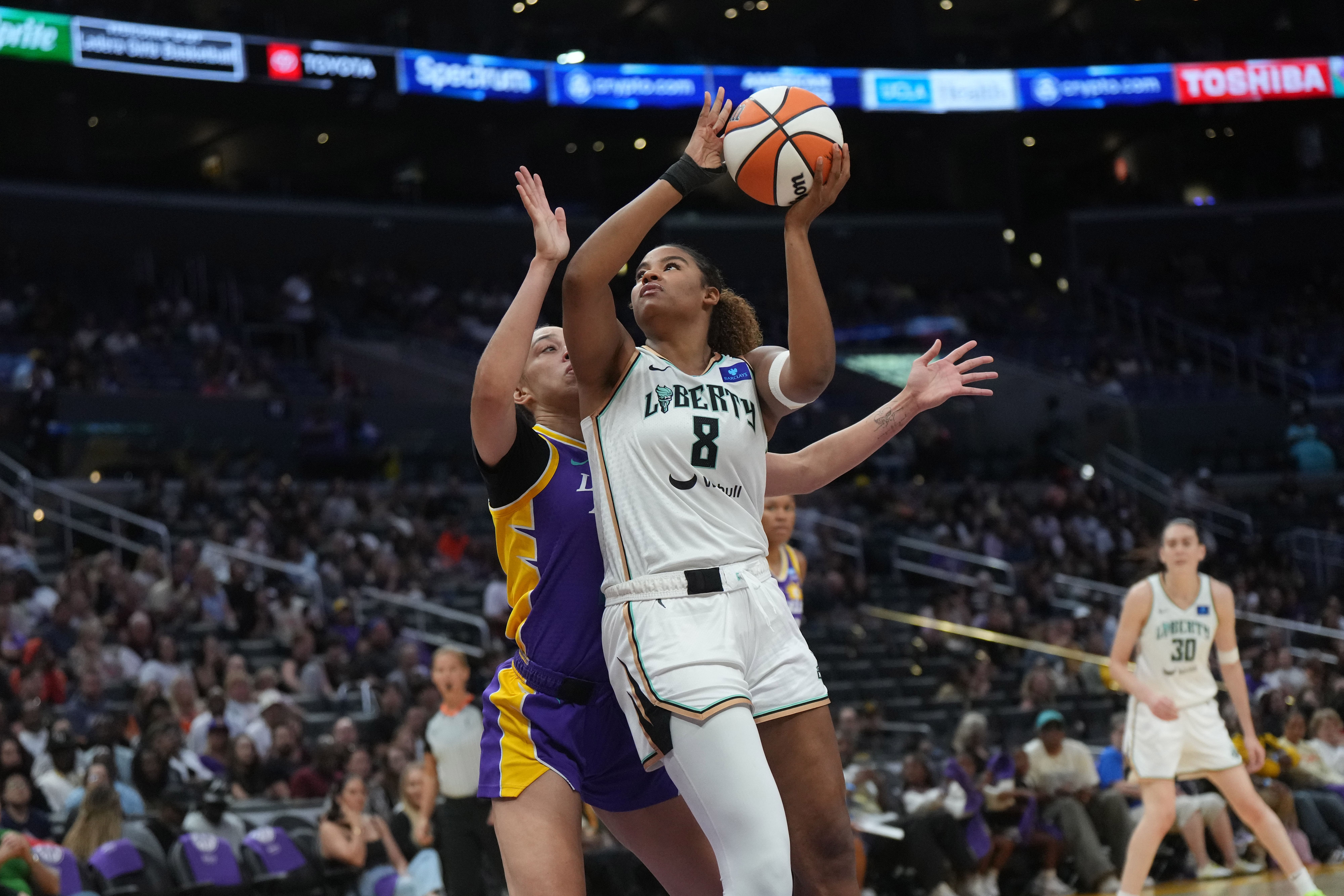 New York Liberty forward Nyara Sabally shoots the ball against LA Sparks forward Dearica Hamby at Crypto.com Arena. Photo Credit: Imagn