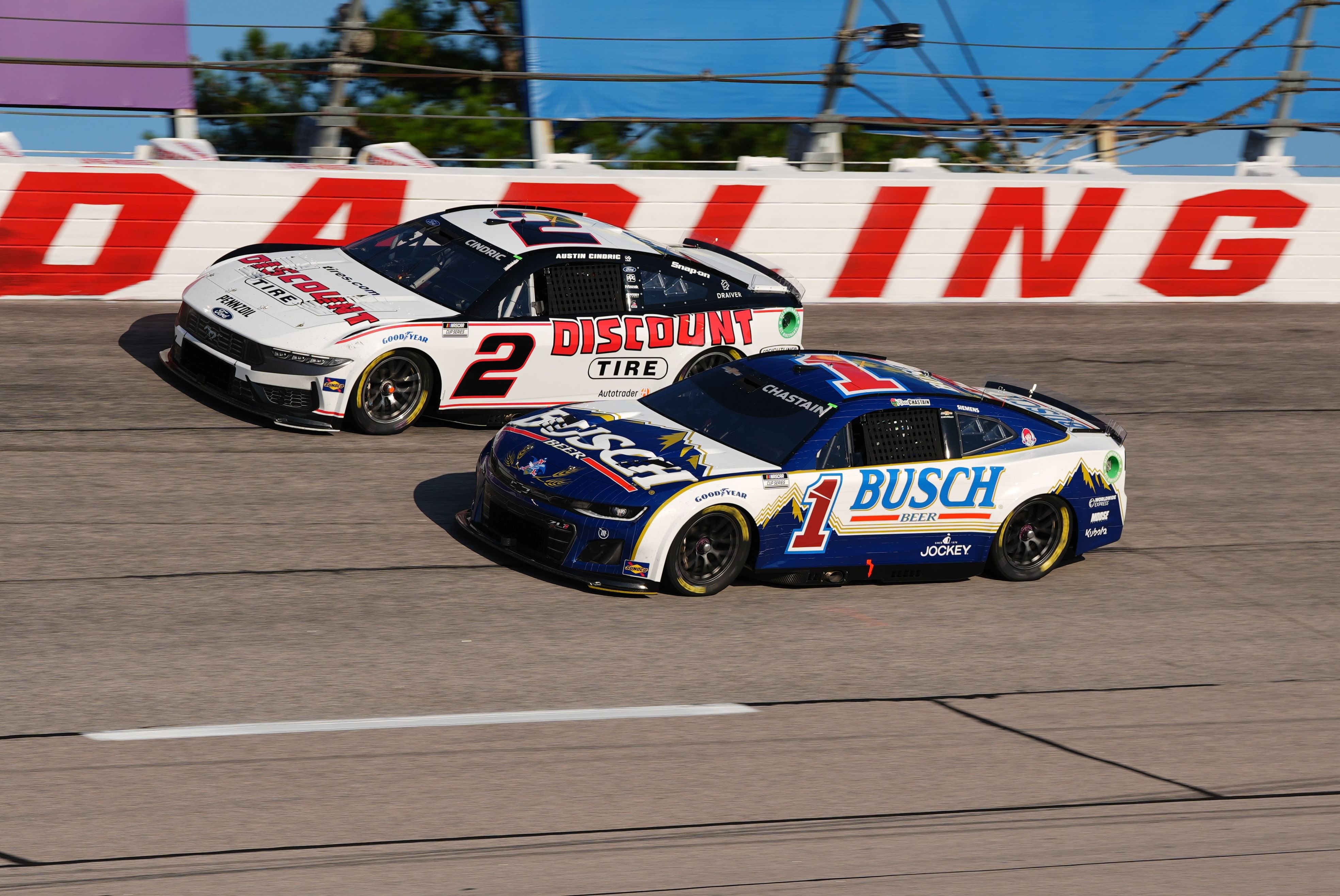 Ross Chastain driving the No. 1 Busch Light Chevy alongside Austin Cindric at Darlington - Source: Imagn