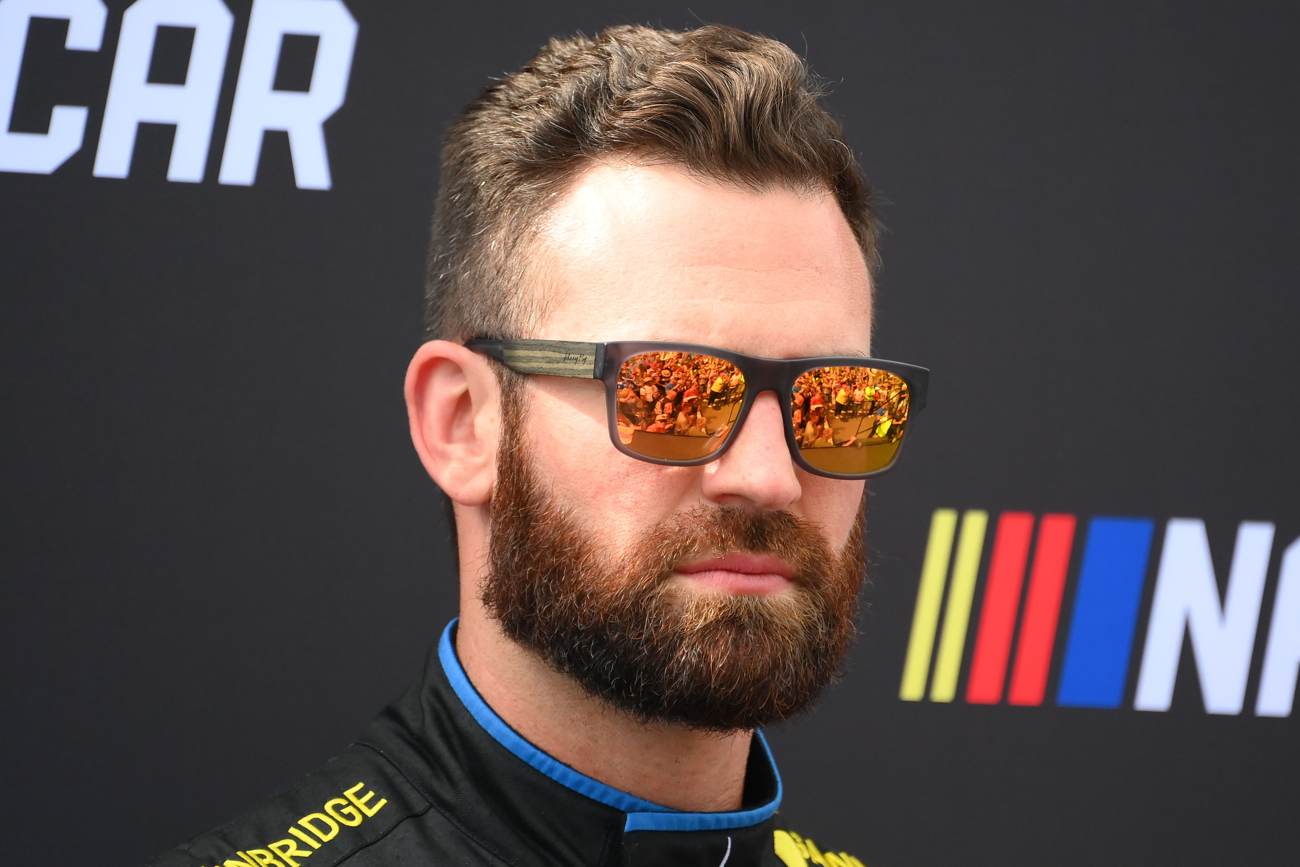 Sep 15, 2024; Watkins Glen, New York, USA; NASCAR Cup Series driver Corey LaJoie (7) looks on prior to the Go Bowling at The Glen at Watkins Glen International. Mandatory Credit: Rich Barnes-Imagn Images - Source: Imagn