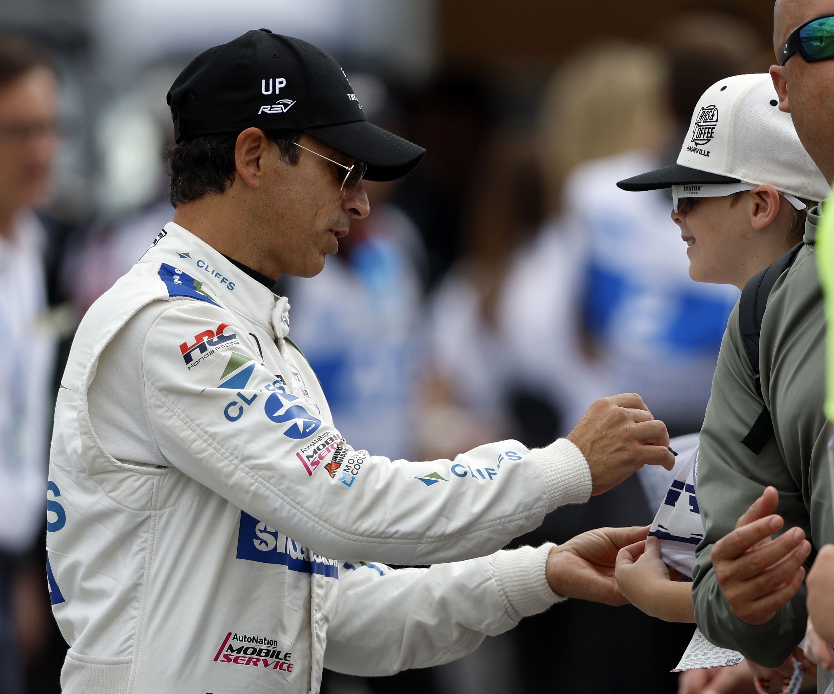 H&eacute;lio Castroneves signs an autograph before the Big Machine Music City Grand Prix at Nashville Superspeedway. - Source: Imagn