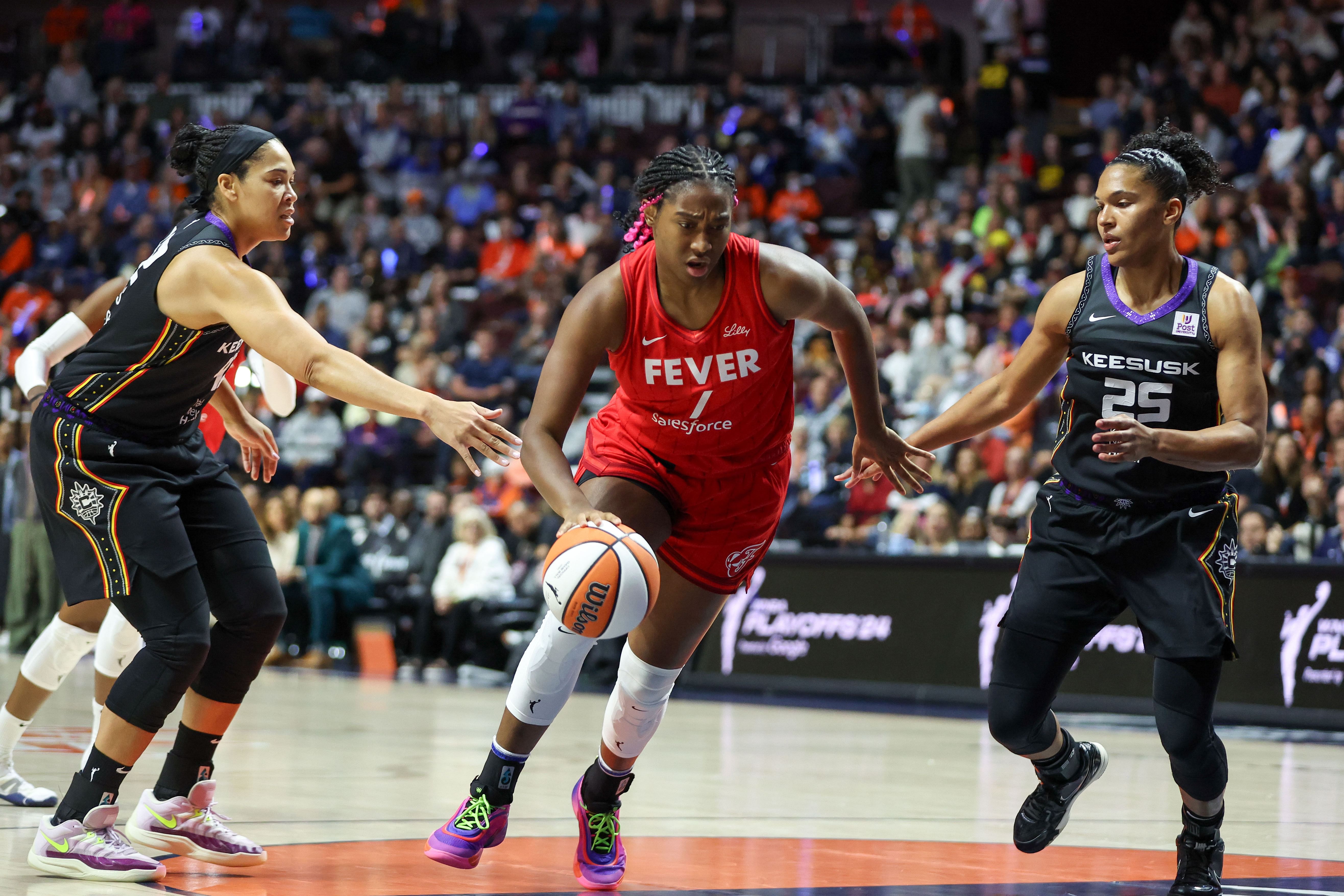 Sep 25, 2024; Uncasville, Connecticut, USA; Indiana Fever forward Aliyah Boston (7) dribbles the ball during the first half against the Connecticut Sun during game two of the first round of the 2024 WNBA Playoffs at Mohegan Sun Arena. Mandatory Credit: Paul Rutherford-Imagn Images - Source: Imagn