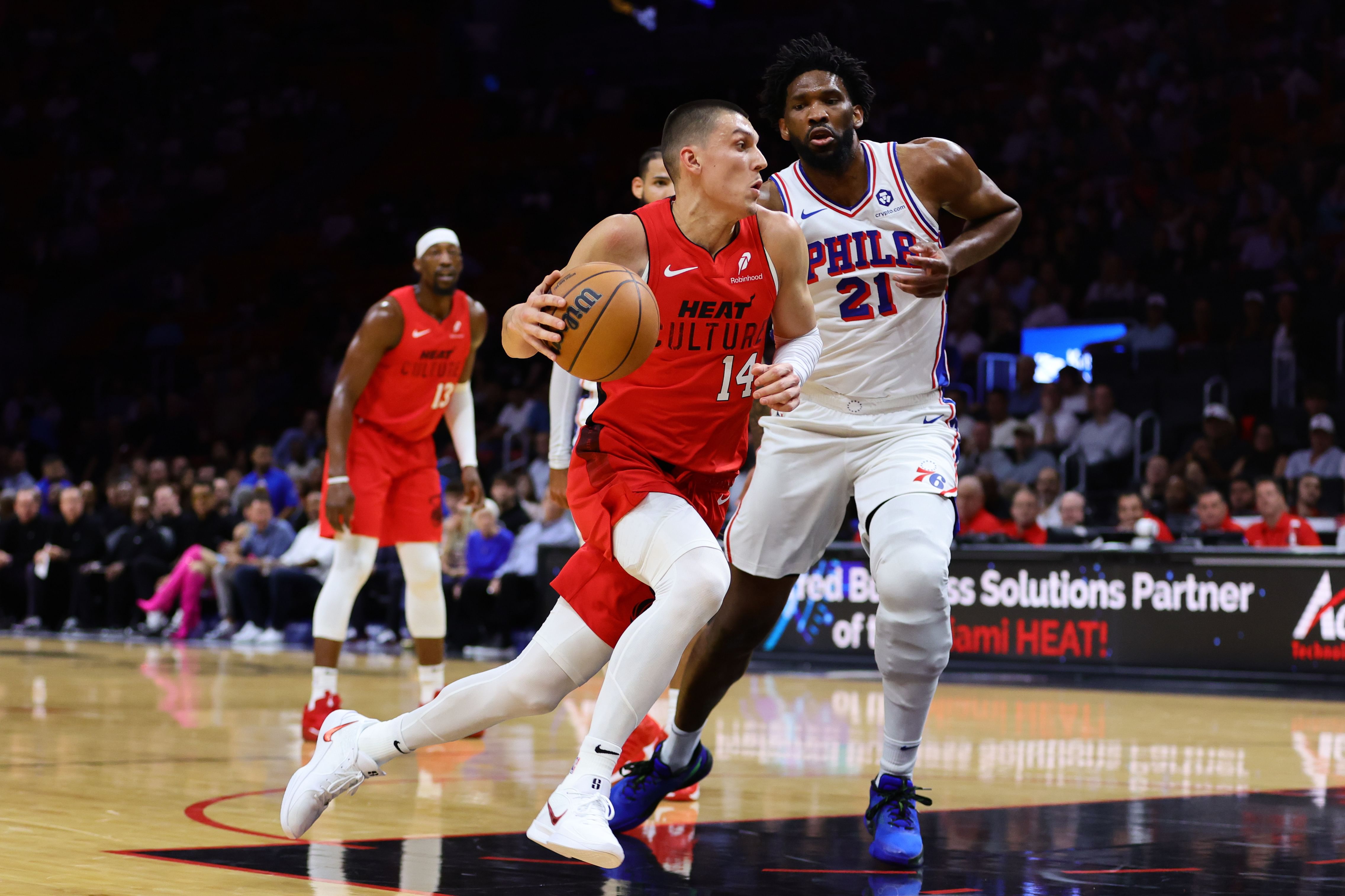 Miami Heat guard Tyler Herro drives to the basket past Philadelphia 76ers center Joel Embiid at Kaseya Center. Photo Credit: Imagn