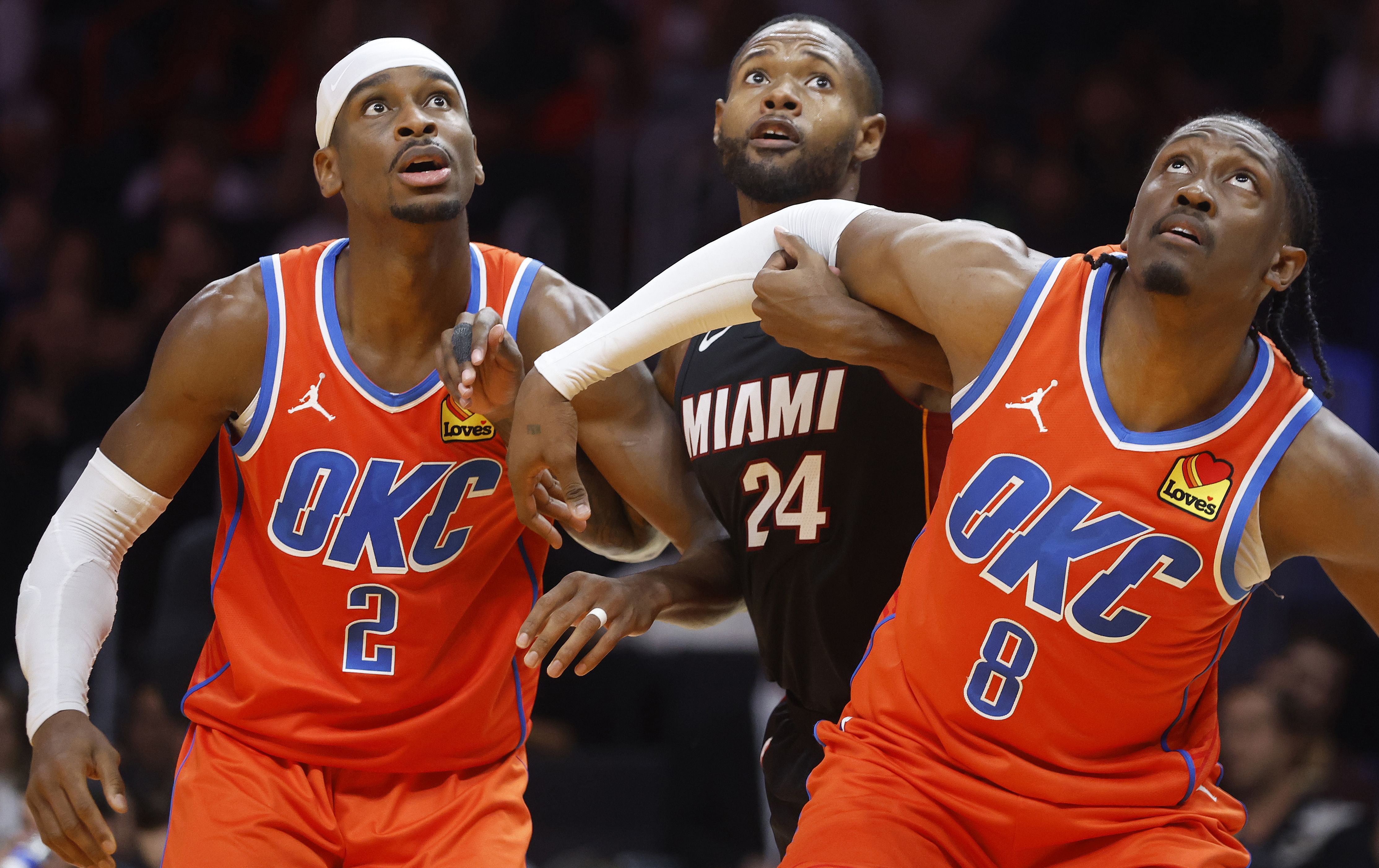 Oklahoma City Thunder guard Shai Gilgeous-Alexander, forward Jalen Williams and Miami Heat forward Haywood Highsmith wait for a rebound at Kaseya Center. Photo Credit: Imagn