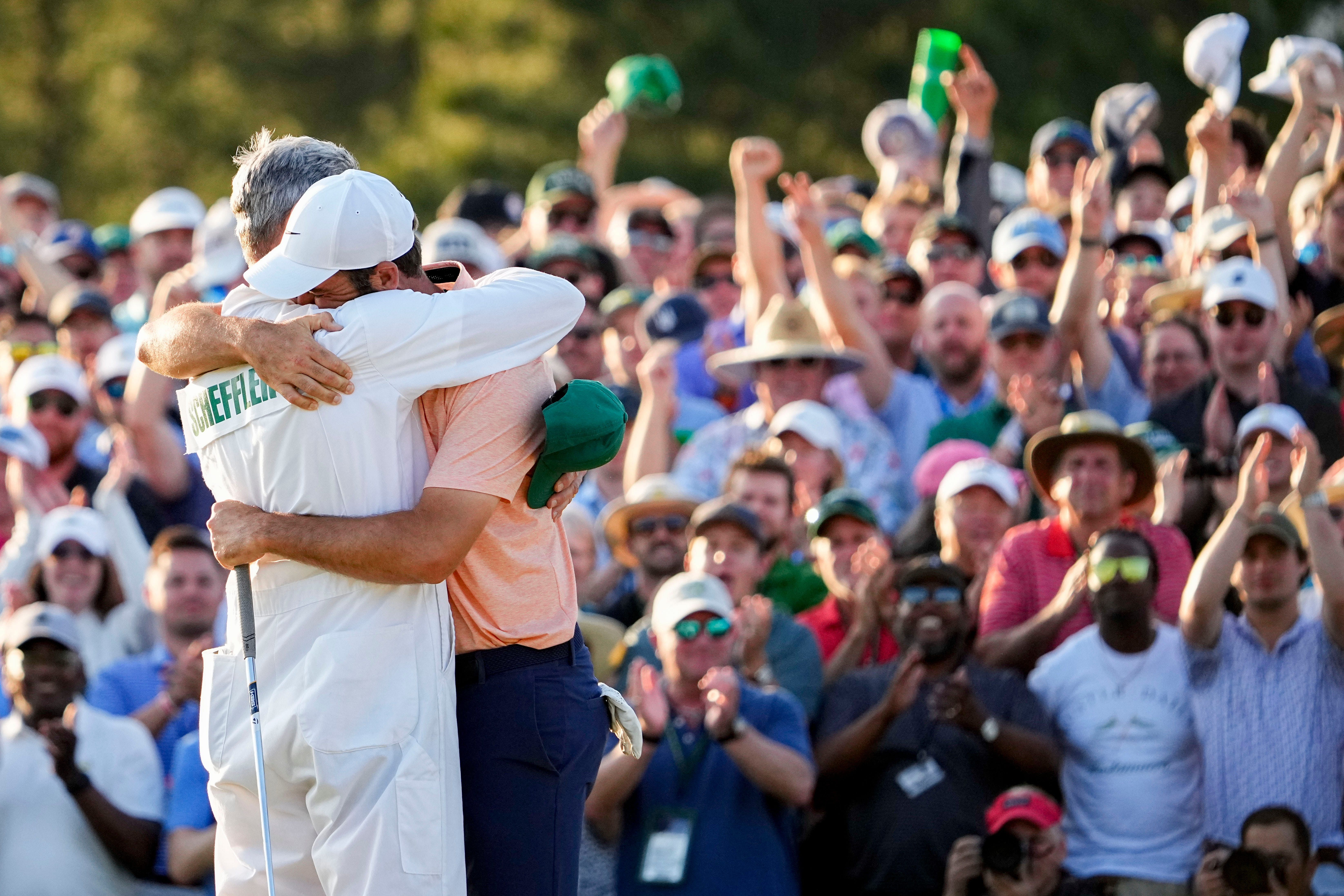 Scottie Scheffler hugs his caddie after winning the 2024 Masters - Source: Imagn