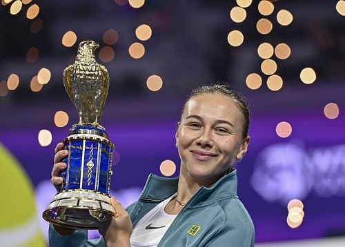 Amanda Anisimova of the United States poses with the trophy after defeating Jelena Ostapenko of Latvia during the WTA Qatar TotalEnergies Open 2025 - Source: Getty