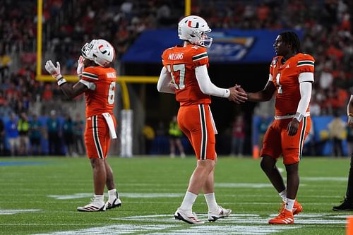 Emory Williams (17) shakes hands with quarterback Cam Ward (1) - Source: Imagn