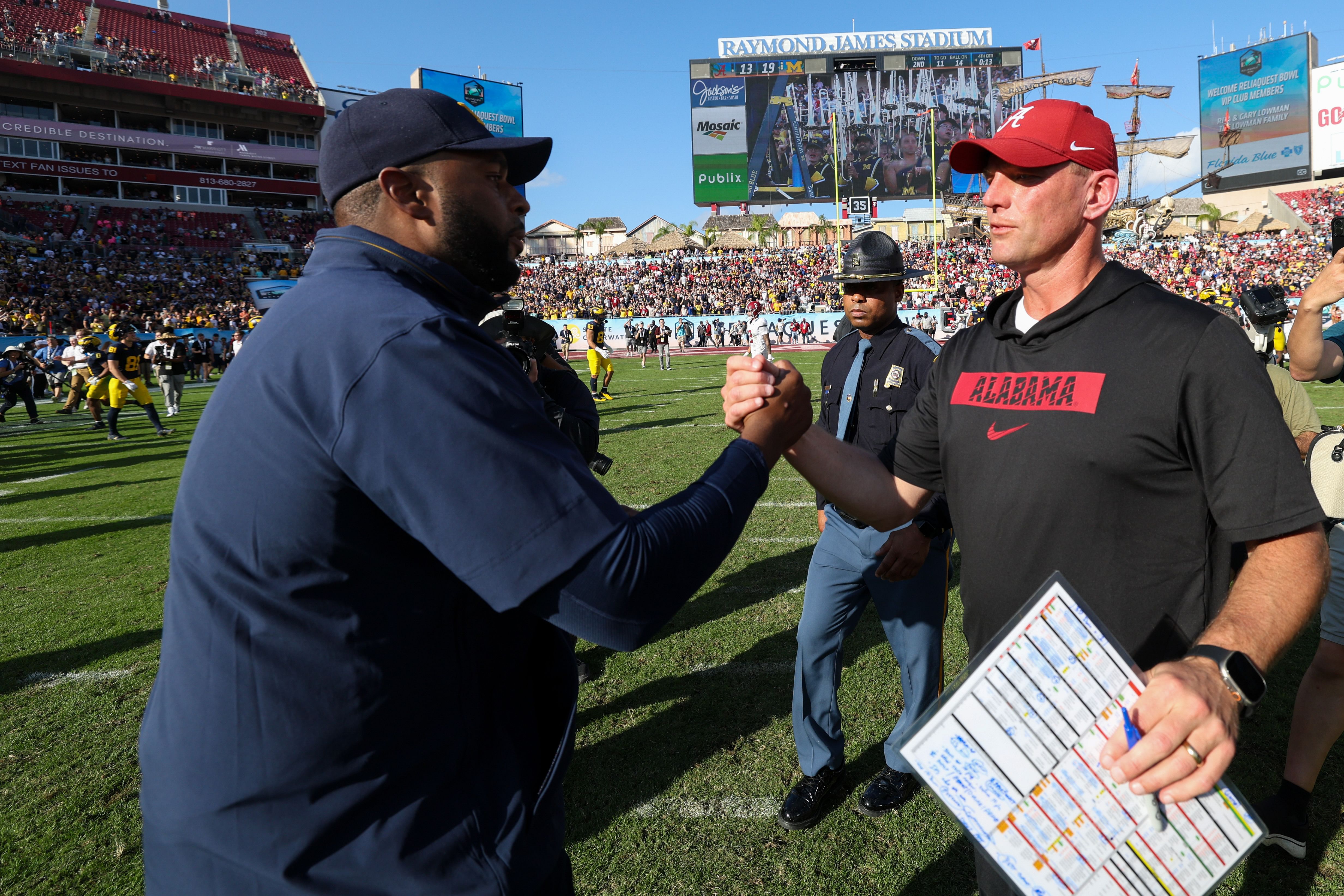 Michigan Wolverines head coach Sherrone Moore greets Alabama Crimson Tide head coach Kalen Deboer - (Credits: IMAGN)