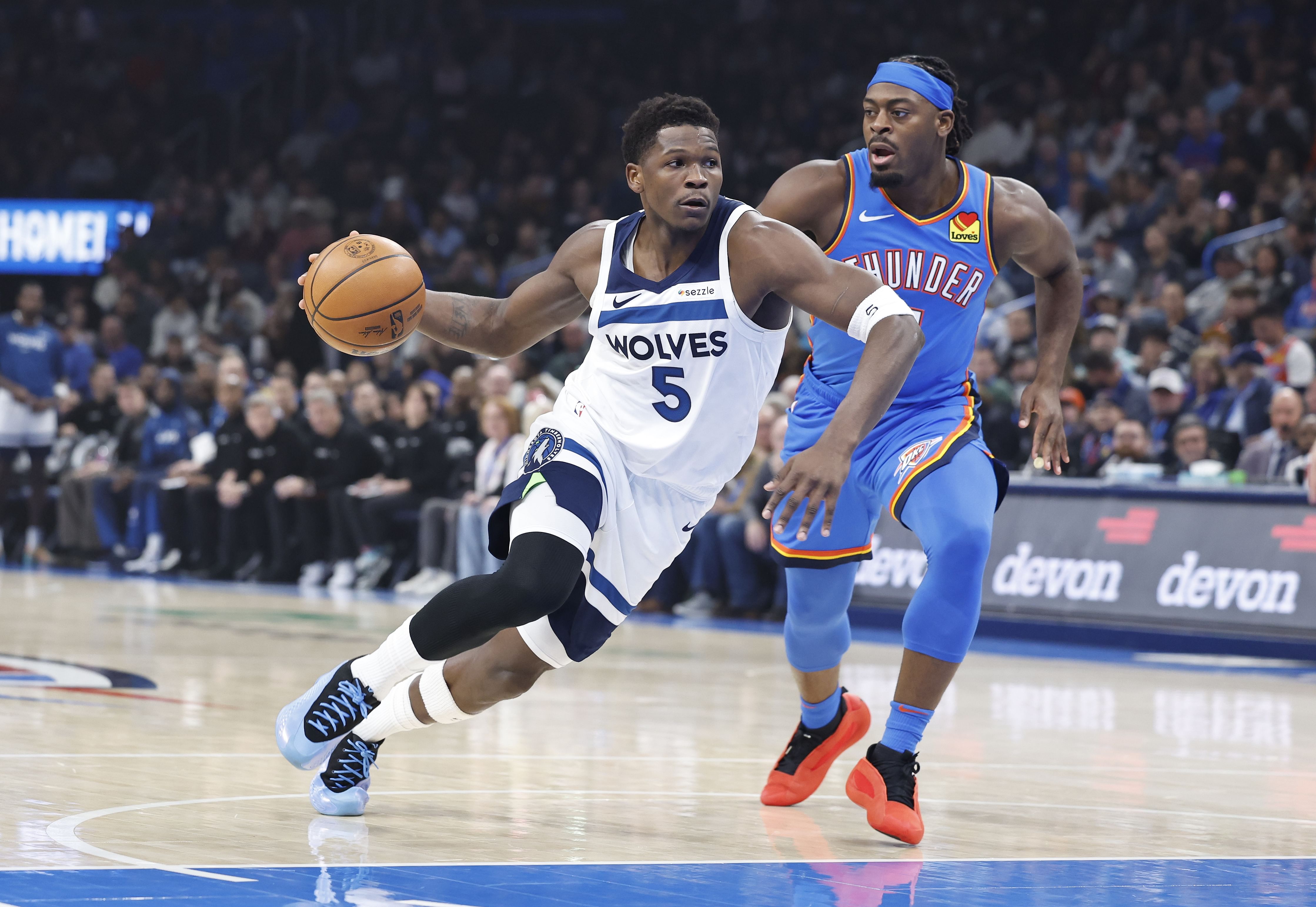 Minnesota Timberwolves guard Anthony Edwards drives to the basket beside OKC Thunder guard Luguentz Dort at Paycom Center. Photo Credit: Imagn