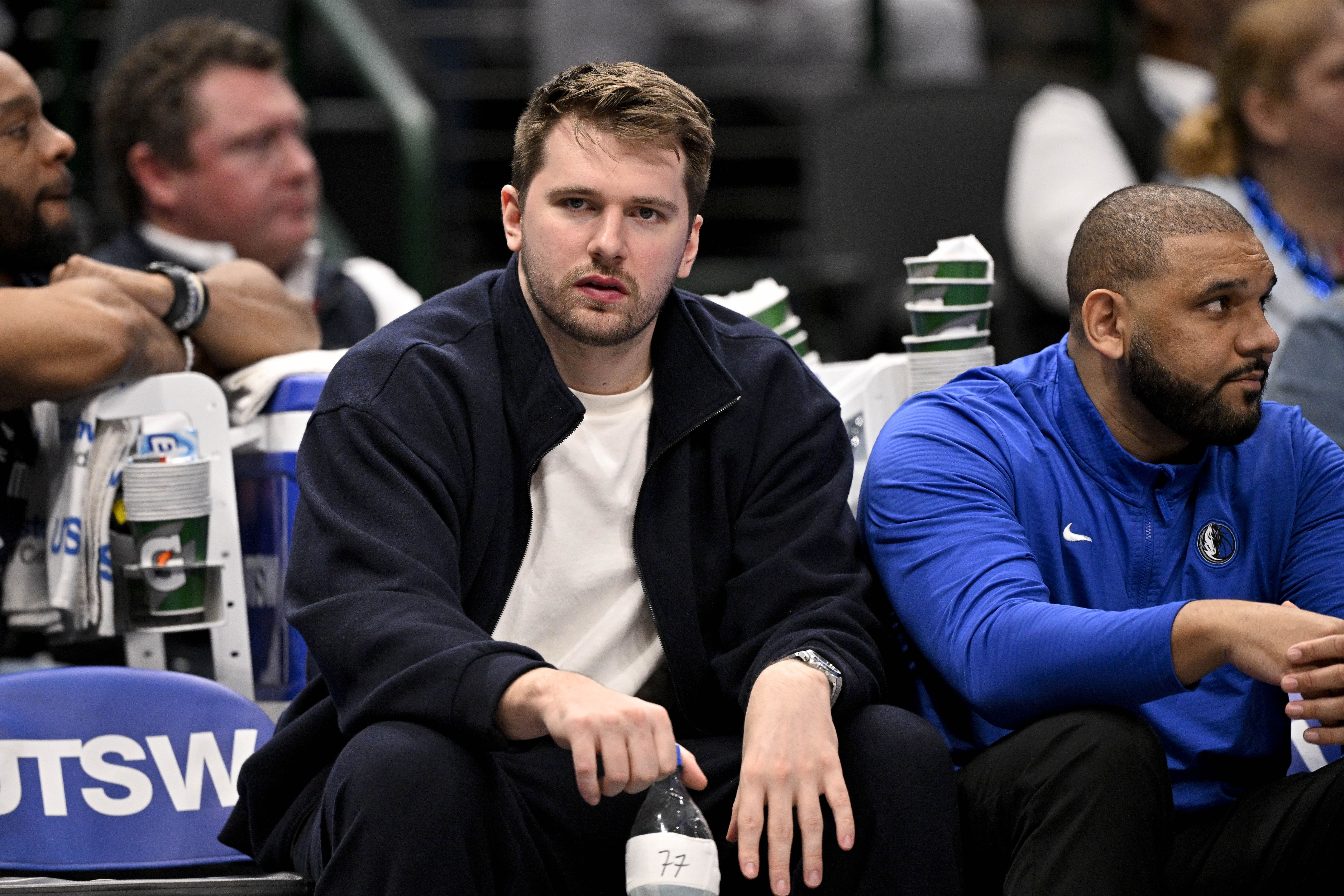 Jan 12, 2025; Dallas, Texas, USA; Dallas Mavericks guard Luka Doncic (77) reacts from the team bench during the second half of the game against the Denver Nuggets at the American Airlines Center. Mandatory Credit: Jerome Miron-Imagn Images - Source: Imagn