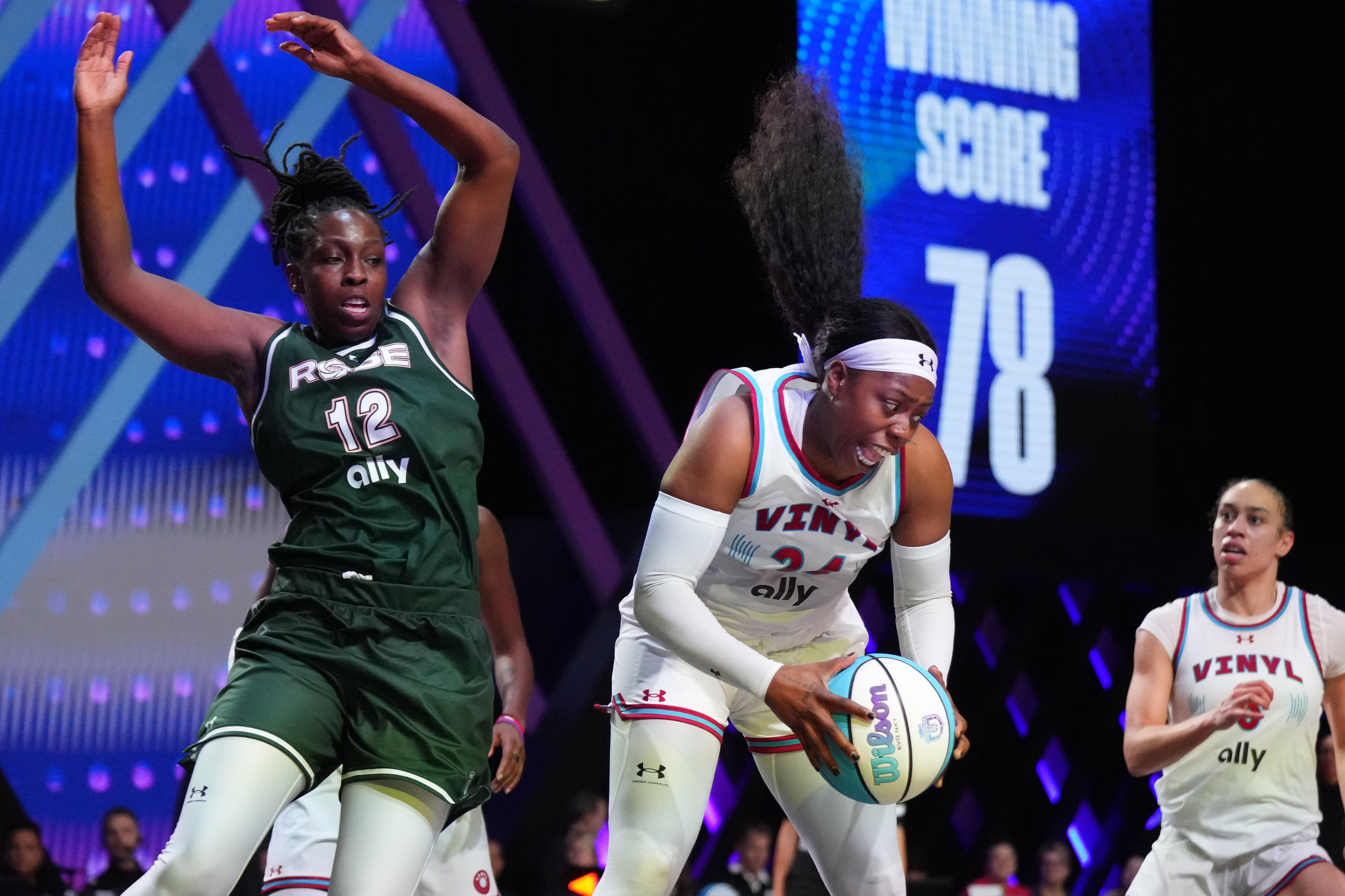 Arike Ogunbowale of the Vinyl BC grabs a rebound over Chelsea Gray of the Rose at Wayfair Arena. Photo Credit: Imagn