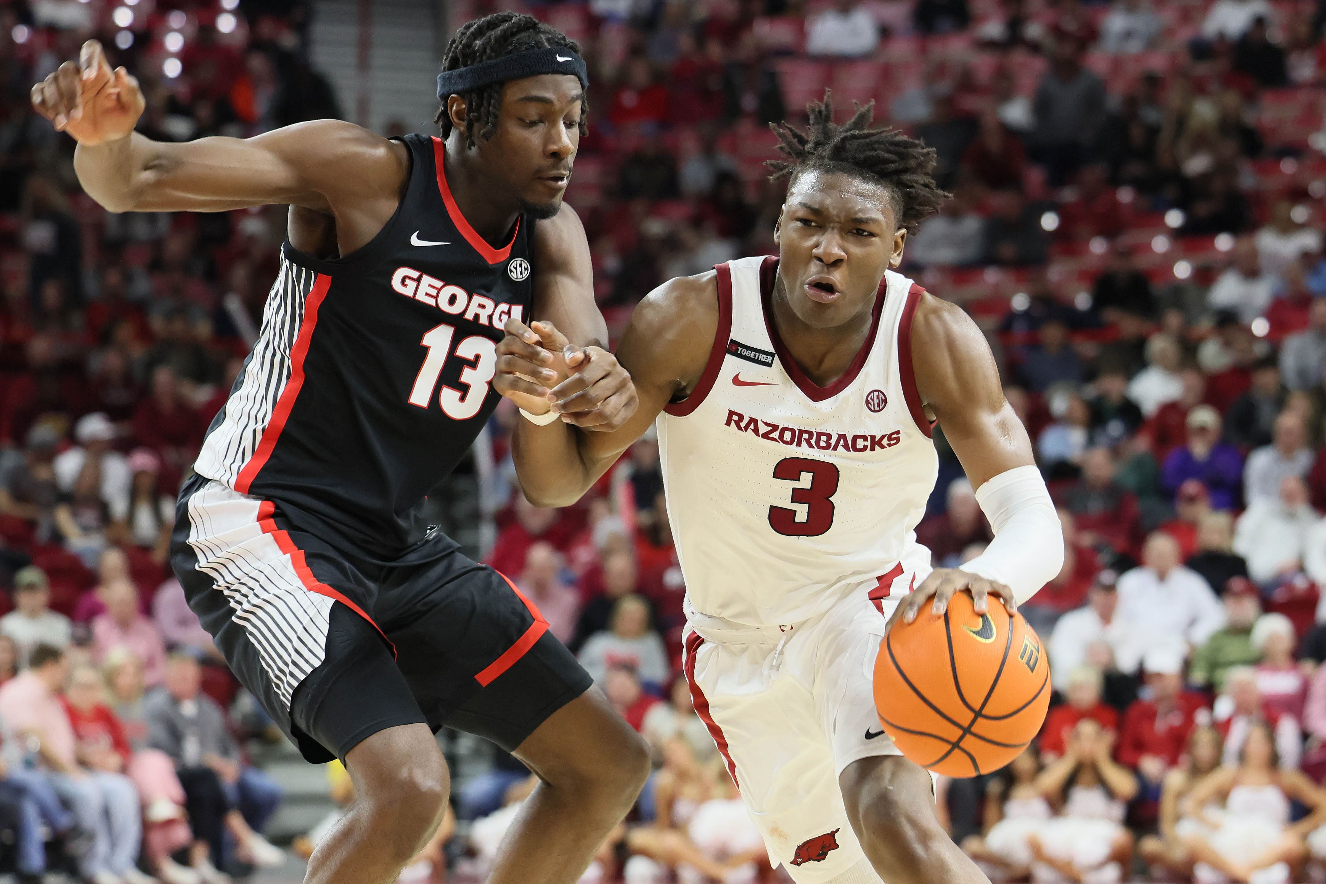 Arkansas Razorbacks forward Adou Thiero (3) drives against Georgia Bulldogs forward Dylan James (13)  - Source: Imagn