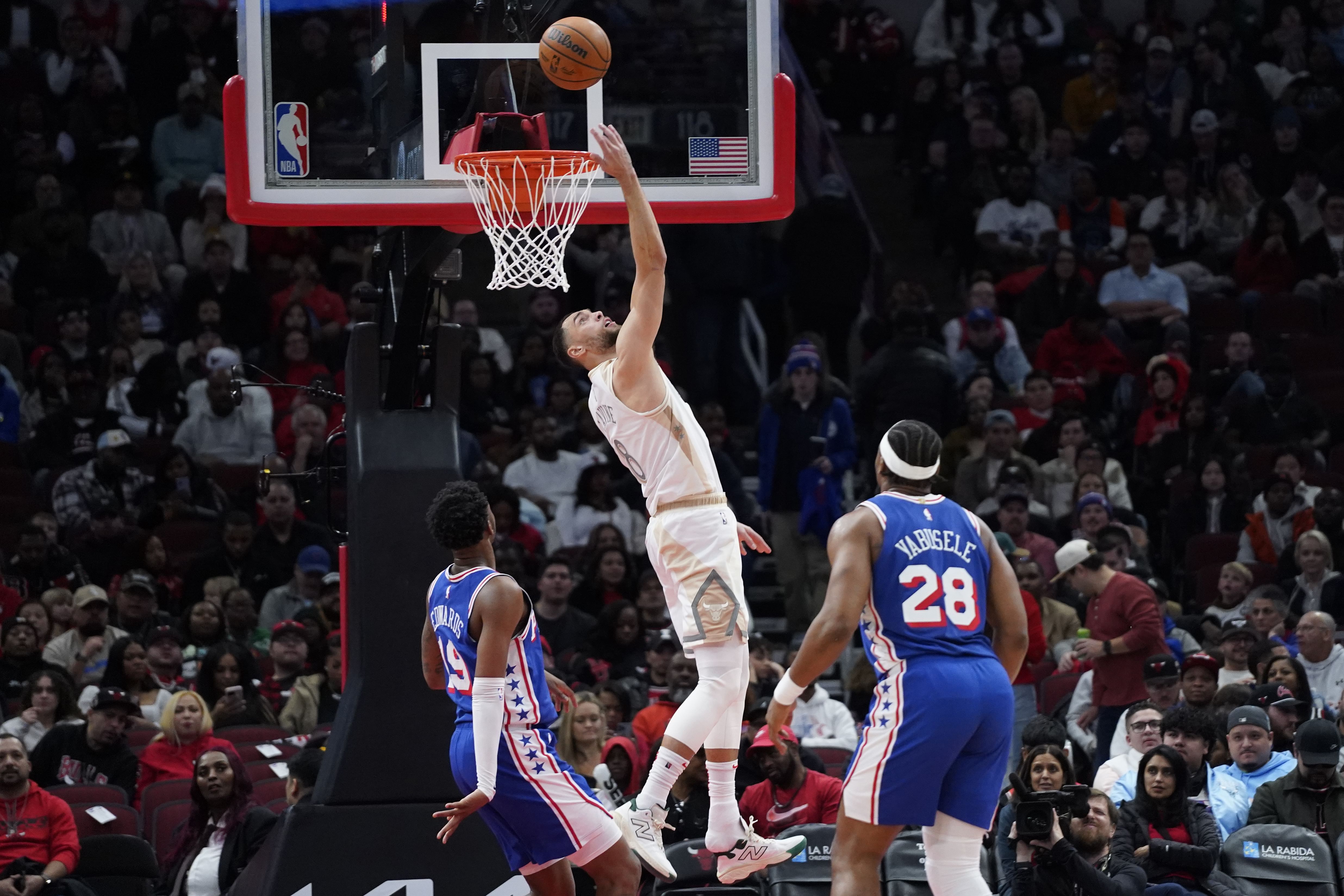 Jan 25, 2025; Chicago, Illinois, USA; Philadelphia 76ers forward Justin Edwards (19) defends Chicago Bulls guard Zach LaVine (8) during the second half at United Center. Mandatory Credit: David Banks-Imagn Images - Source: Imagn