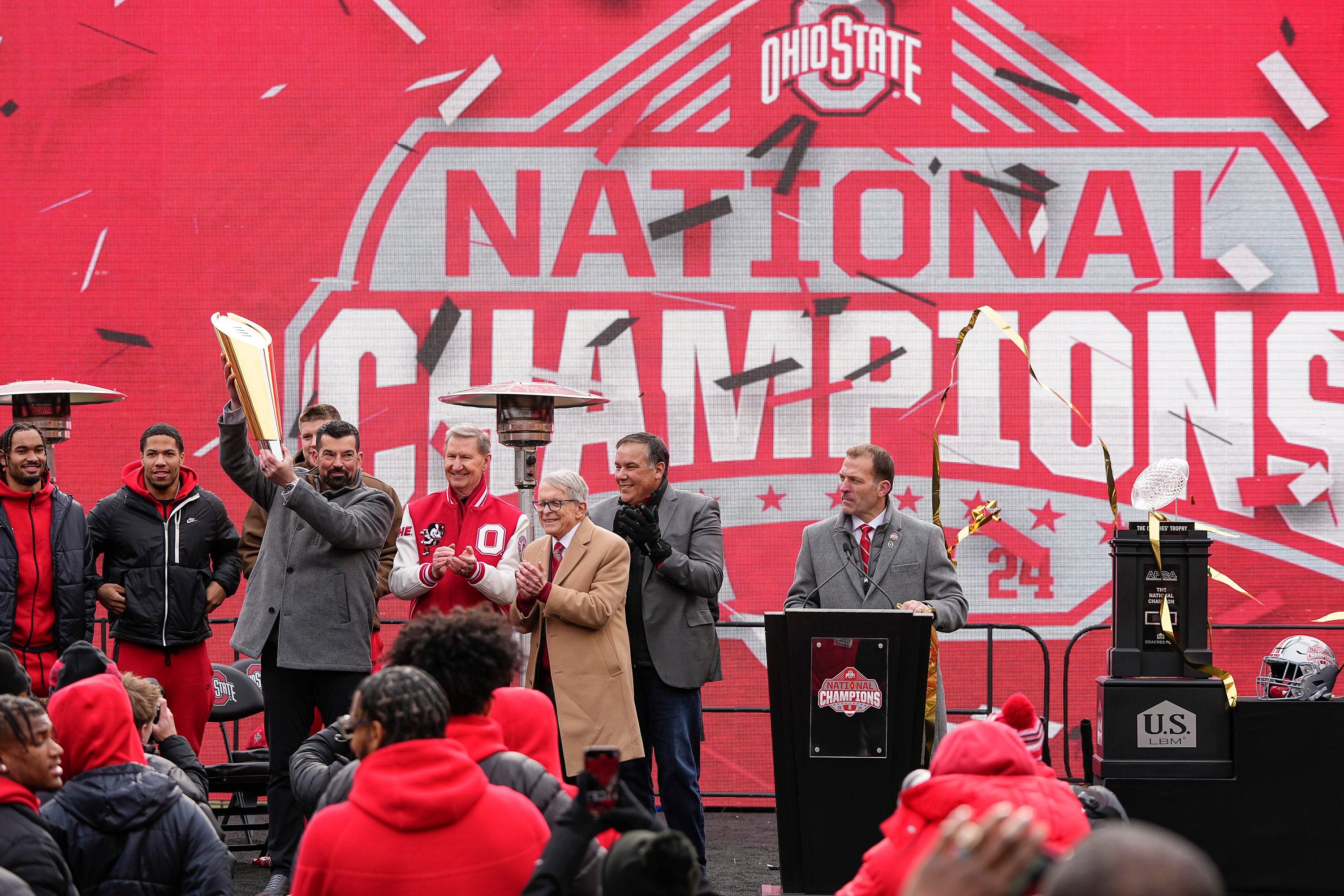 Buckeyes coach Day hoists the College Football Playoff trophy - Source: Imagn