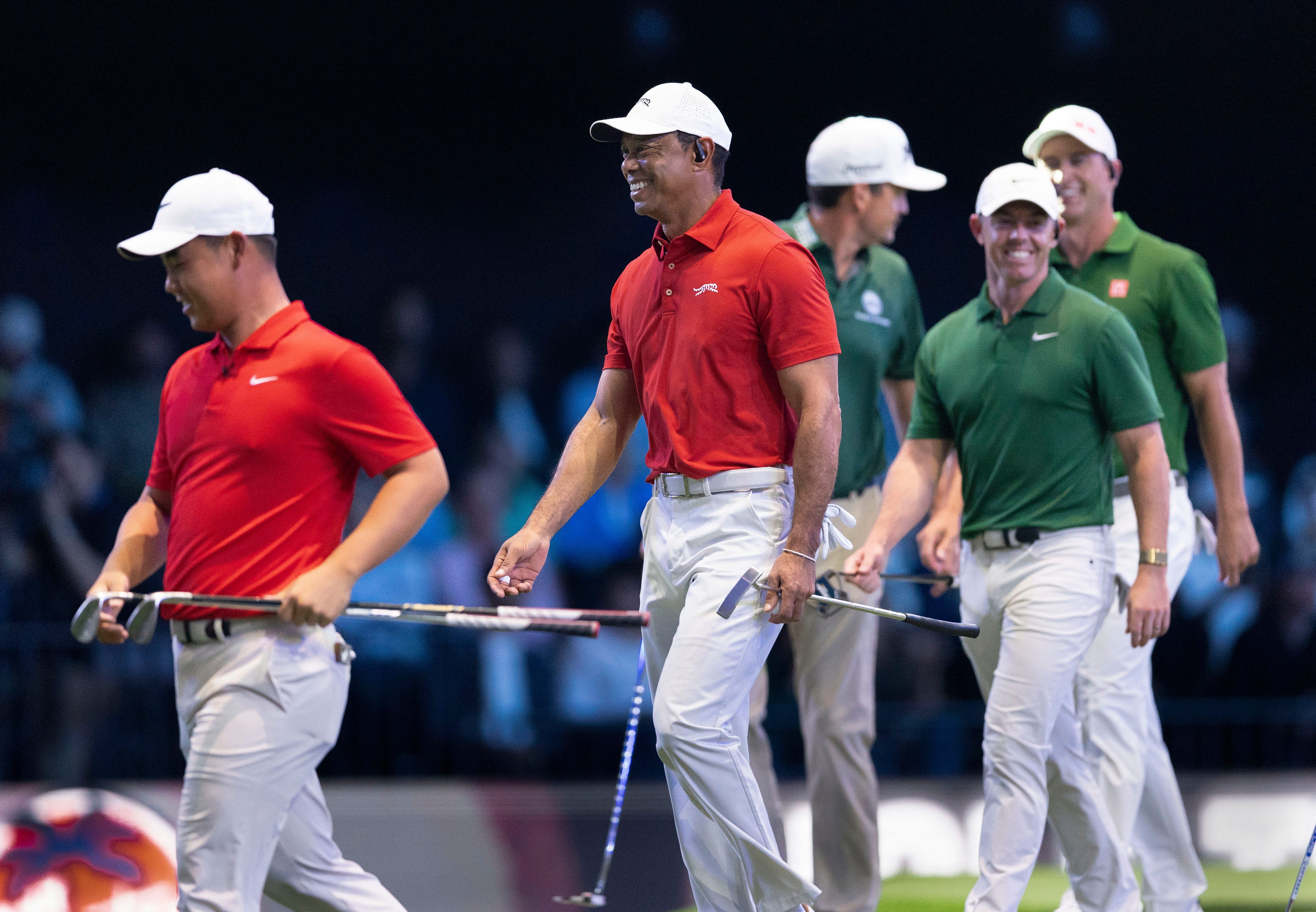 Tiger Woods and Tom Kim of Jupiter Links GC enjoy their match against Keegan Bradley, Rory McIlroy, and Adam Scott of Boston Common during a TGL match - Source: Imagn