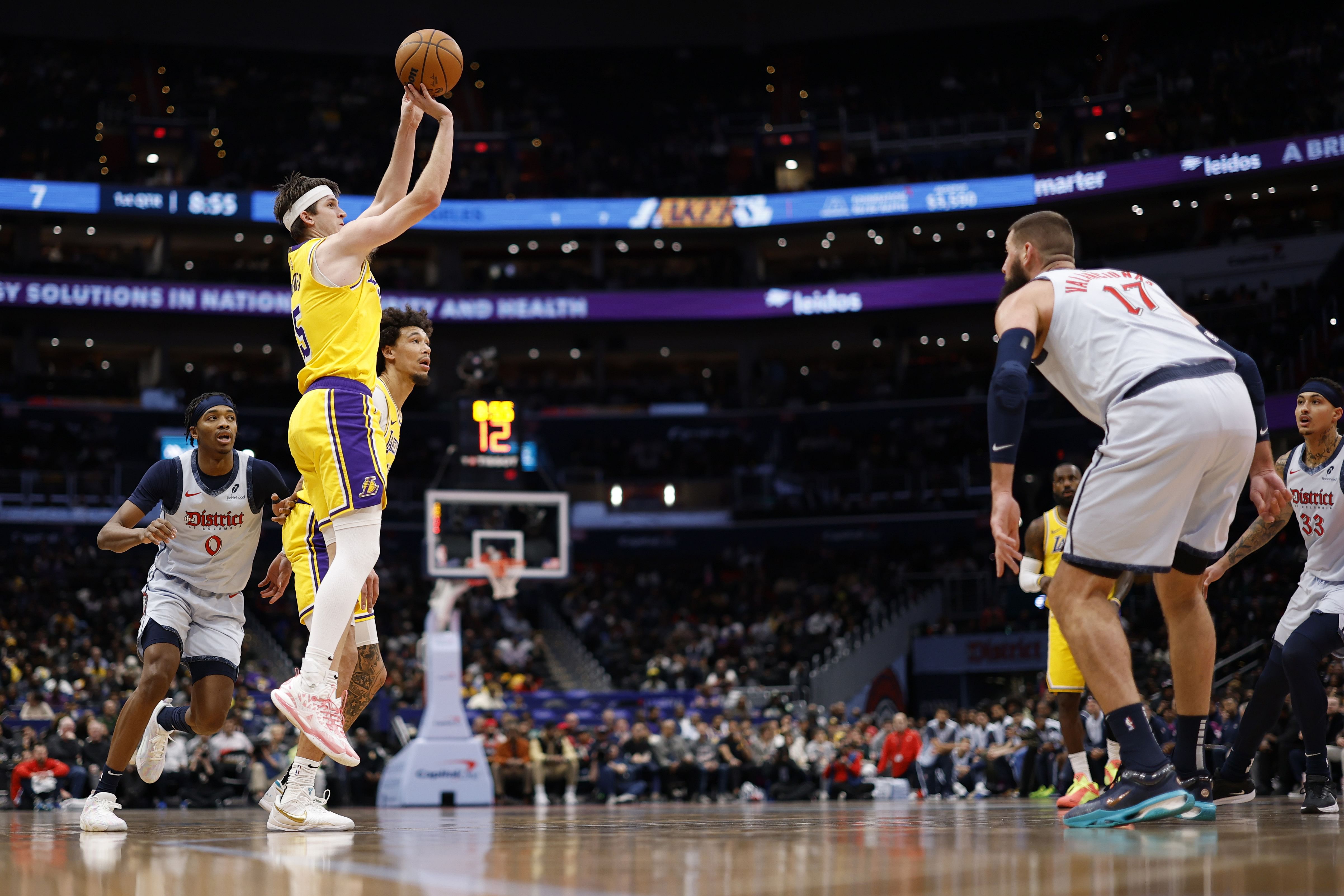 Los Angeles Lakers guard Austin Reaves (15) shoots the ball during an NBA game. (Credits: IMAGN)