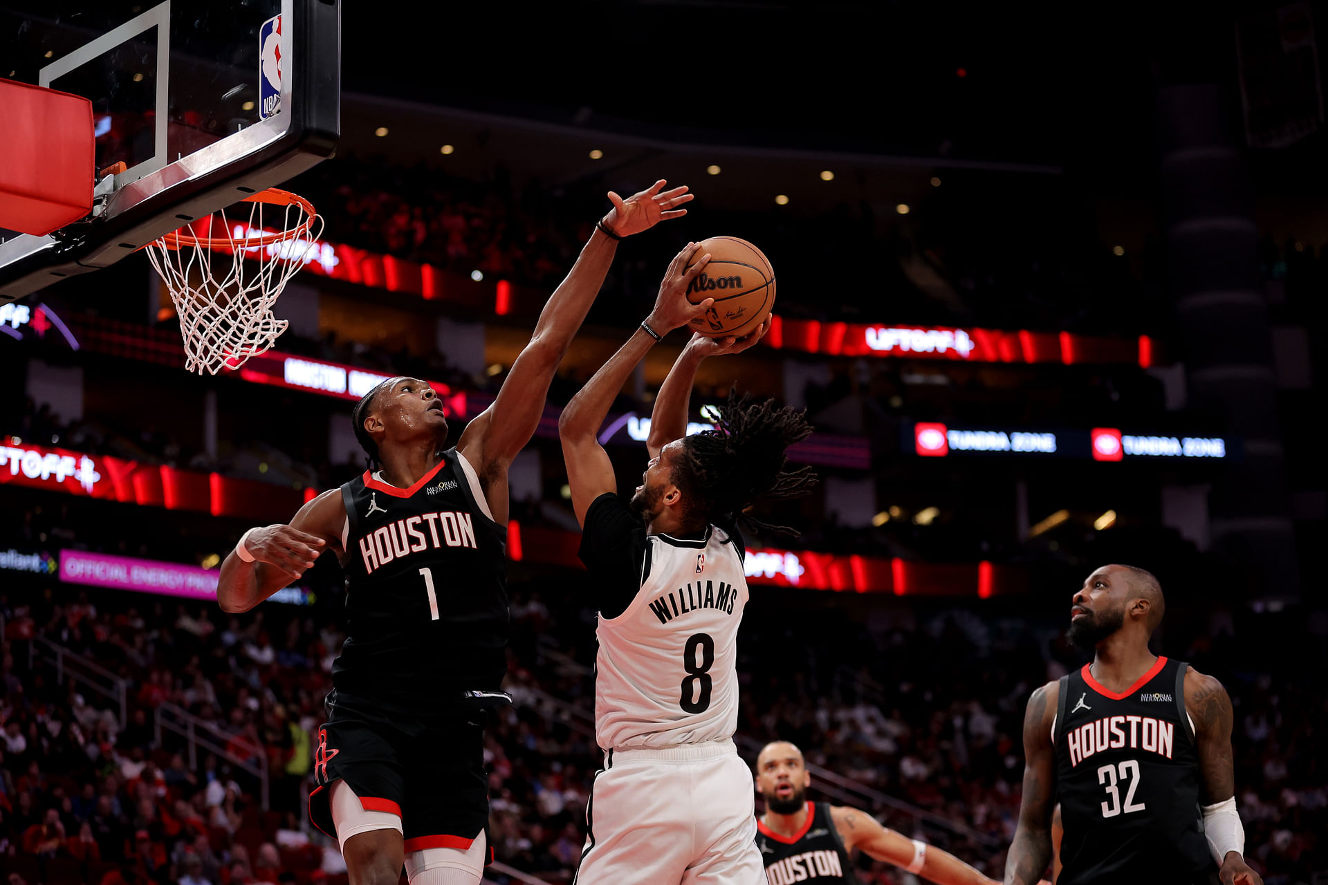 Feb 1, 2025; Houston, Texas, USA; Houston Rockets guard Amen Thompson (1) defends a shot by Brooklyn Nets forward Ziaire Williams (8) during the third quarter at Toyota Center. Mandatory Credit: Erik Williams-Imagn Images - Source: Imagn