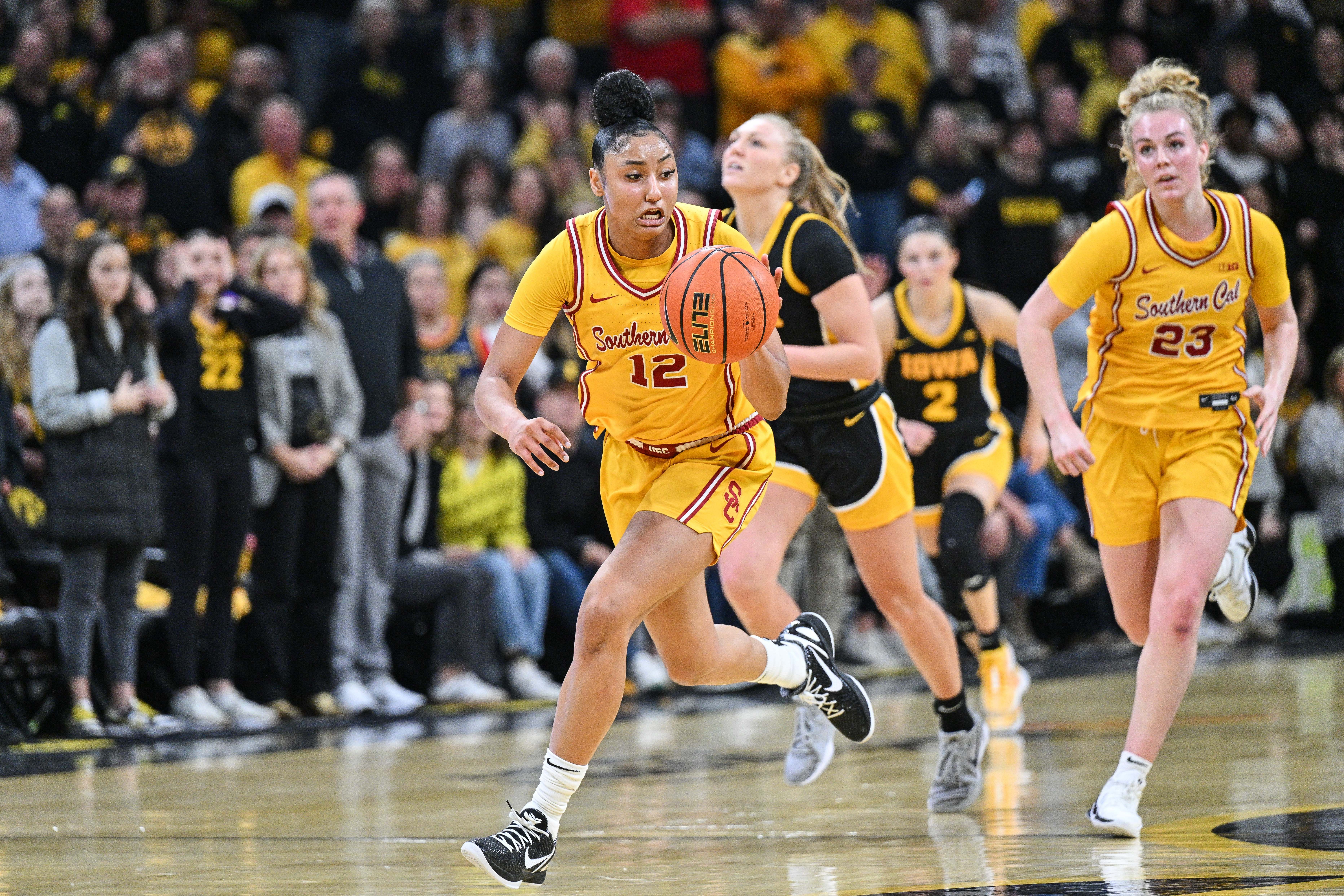 USC Trojans guard JuJu Watkins (#12) drives the ball late during the second quarter against the Iowa Hawkeyes as guard Avery Howell (23) looks on at Carver-Hawkeye Arena. Photo: Imagn