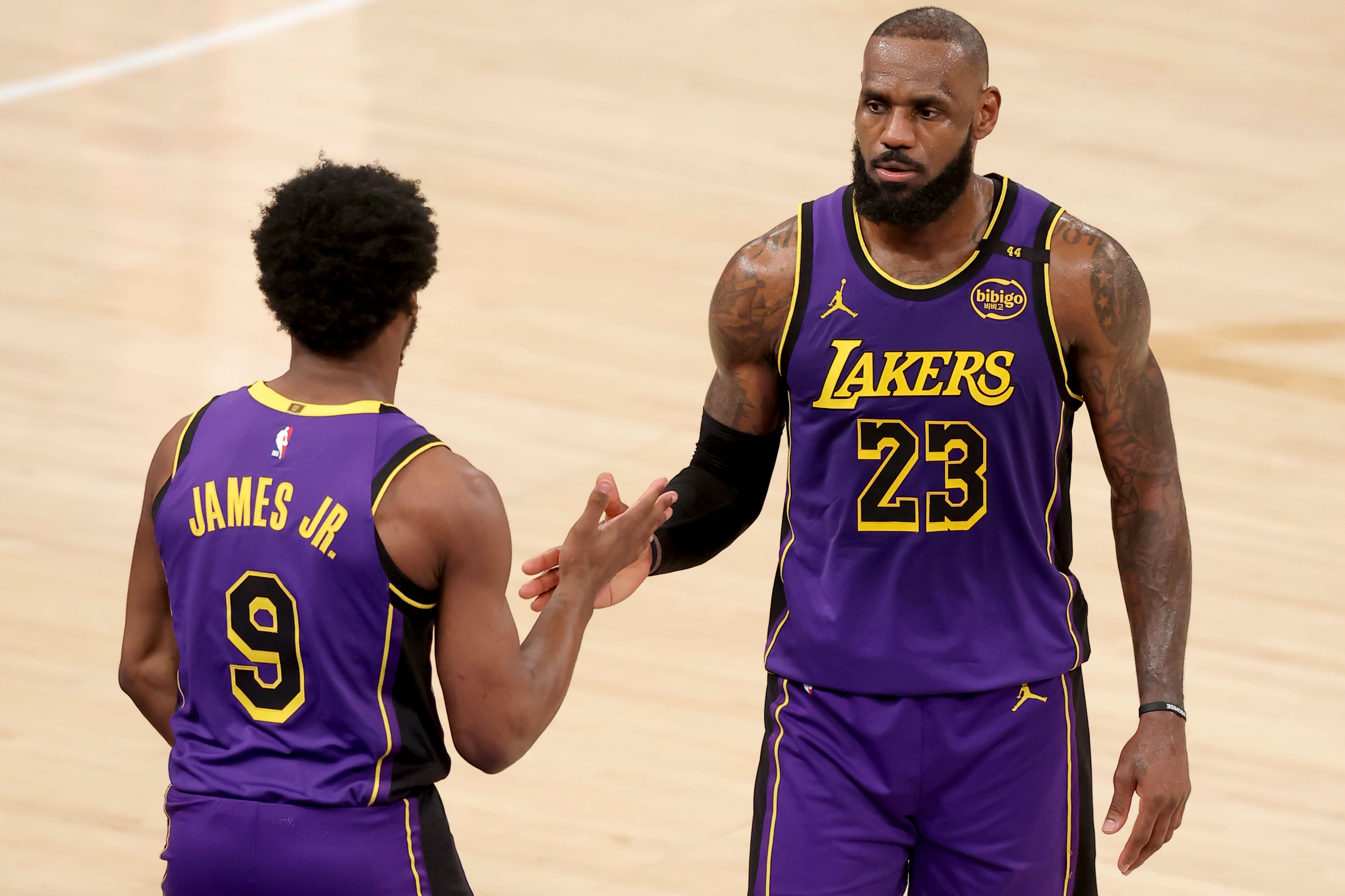 Feb 1, 2025; New York, New York, USA; Los Angeles Lakers guard Bronny James (9) checks in for forward LeBron James (23) during the fourth quarter against the New York Knicks at Madison Square Garden. Mandatory Credit: Brad Penner-Imagn Images - Source: Imagn