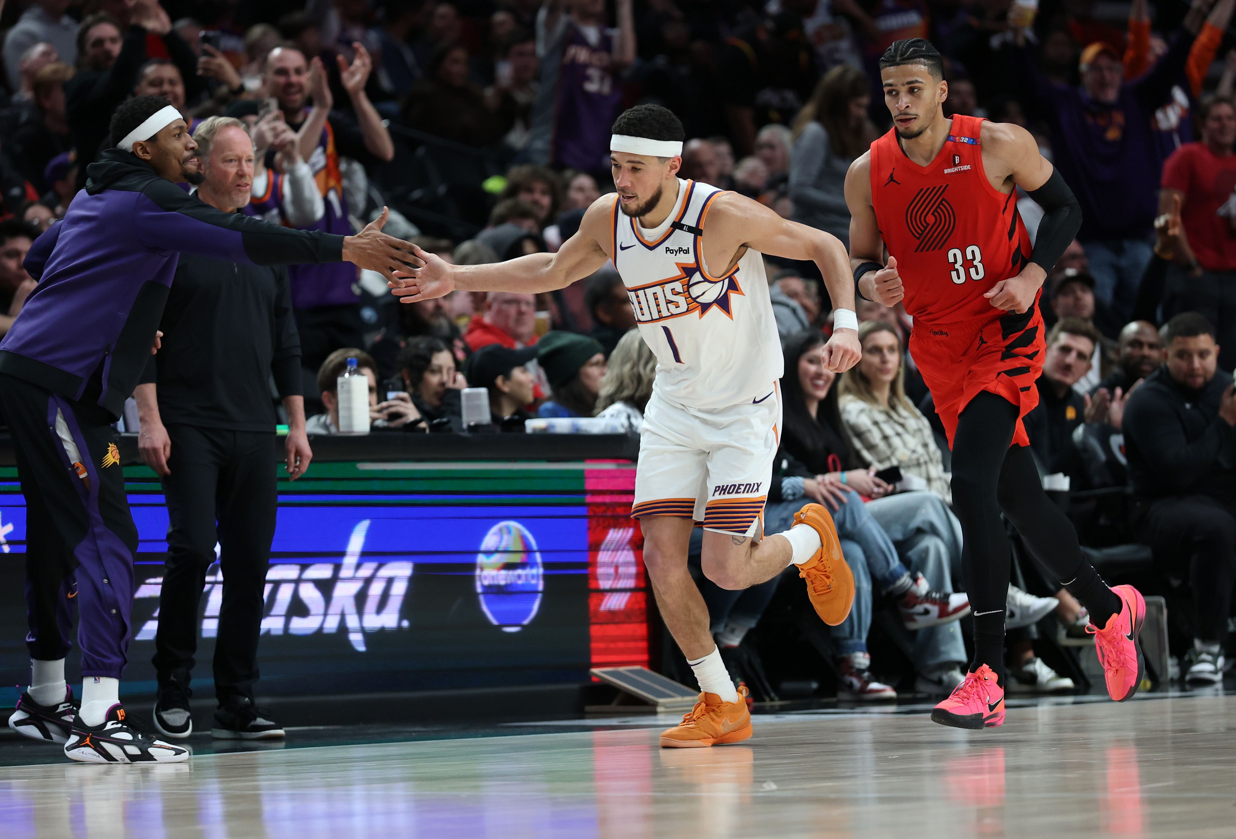 Feb 3, 2025; Portland, Oregon, USA; Phoenix Suns guard Devin Booker (1) reacts after scoring against the Portland Trail Blazers to make Booker the Suns&rsquo; all-time leading scorer in the second half at Moda Center. Mandatory Credit: Jaime Valdez-Imagn Images - Source: Imagn