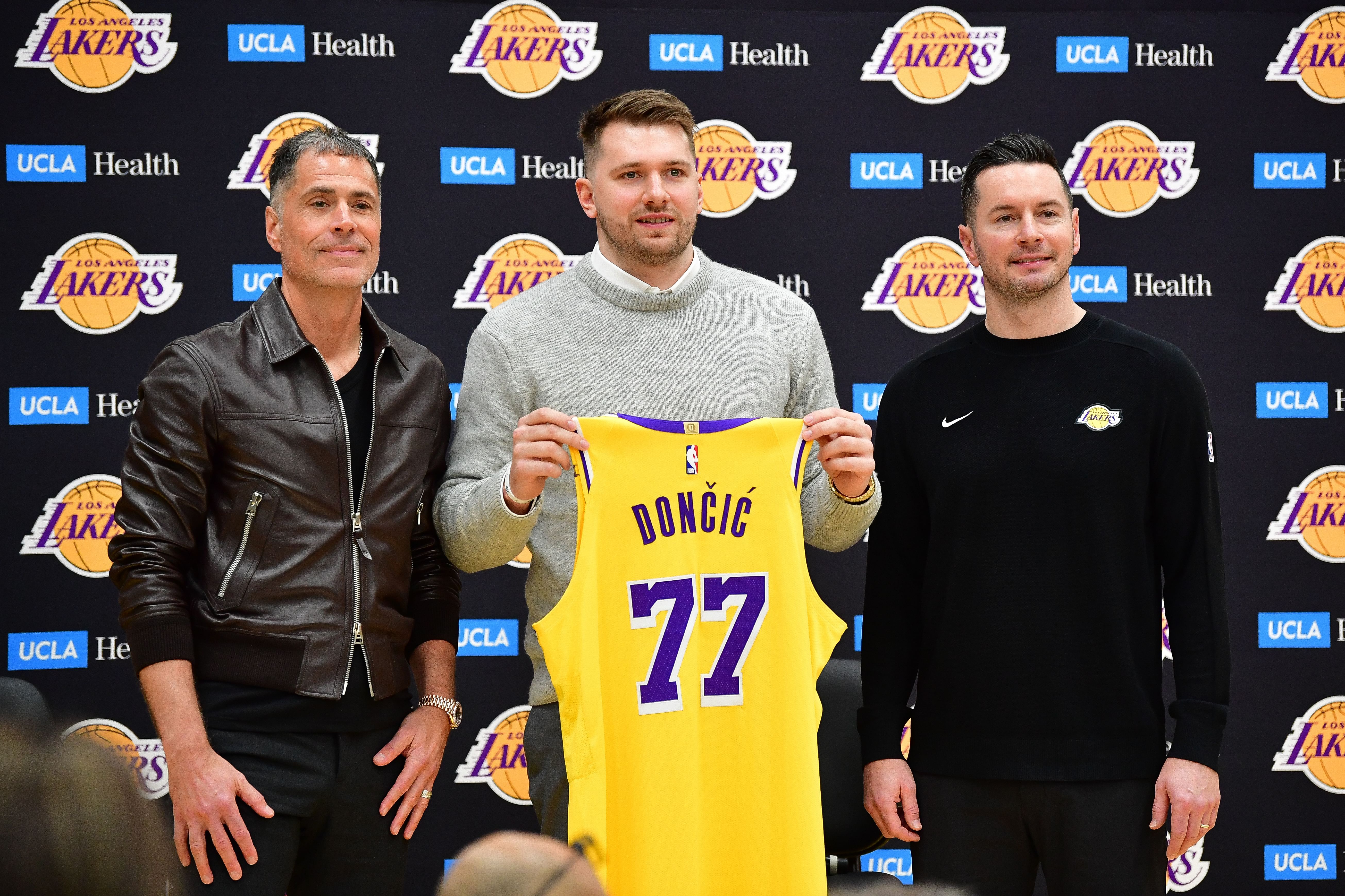 Los Angeles Lakers guard Luka Doncic poses for photos with general manager Rob Pelinka and head coach JJ Redick at UCLA Health Training Center. Mandatory Credit: Imagn