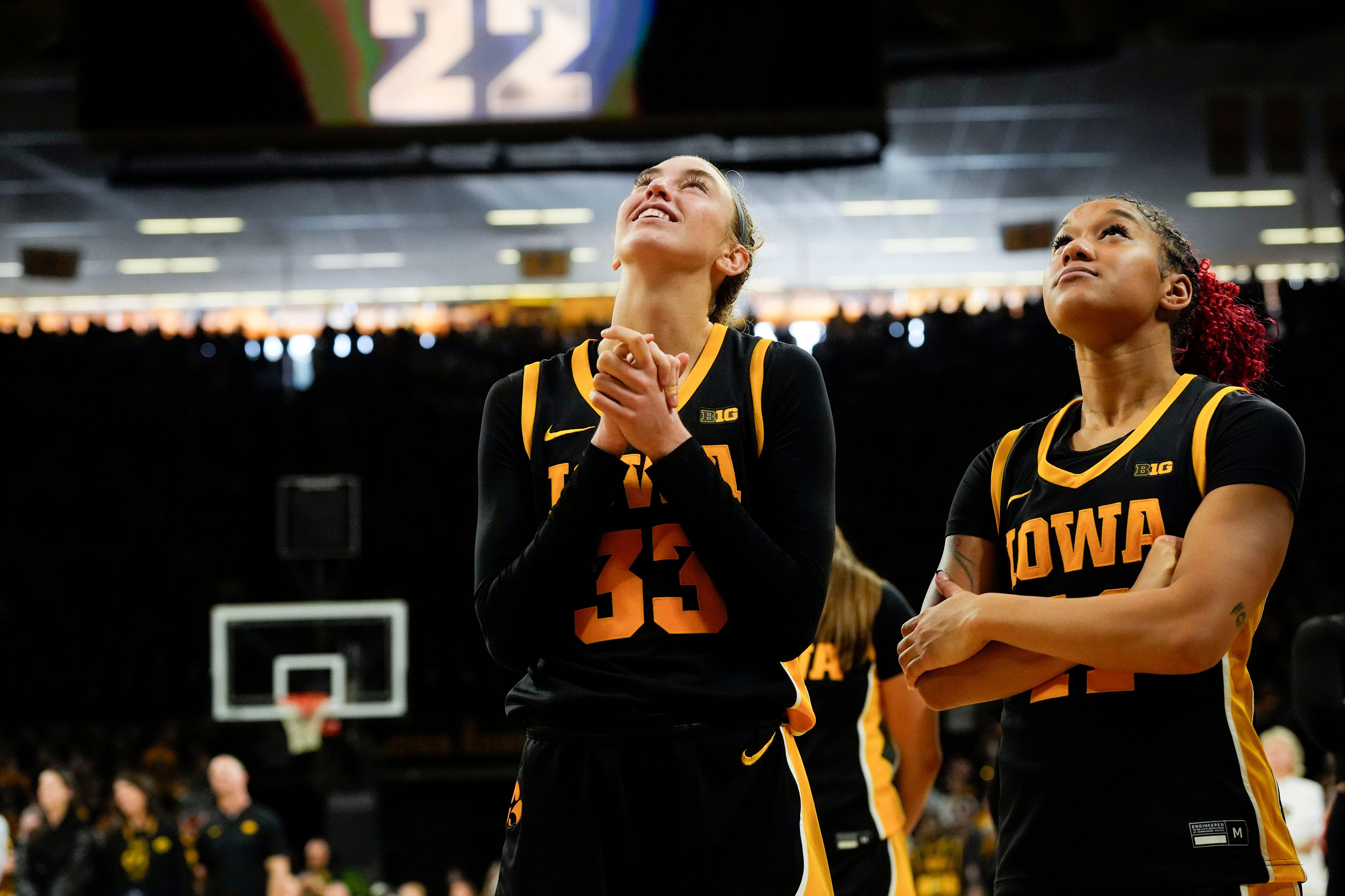 Iowa Hawkeyes guard Lucy Olsen (33) and Iowa Hawkeyes guard Aaliyah Guyton (11) watch Caitlin Clark&rsquo;s jersey be retired Sunday, Feb. 2, 2025 at Carver-Hawkeye Arena in Iowa City, Iowa. - Source: Imagn